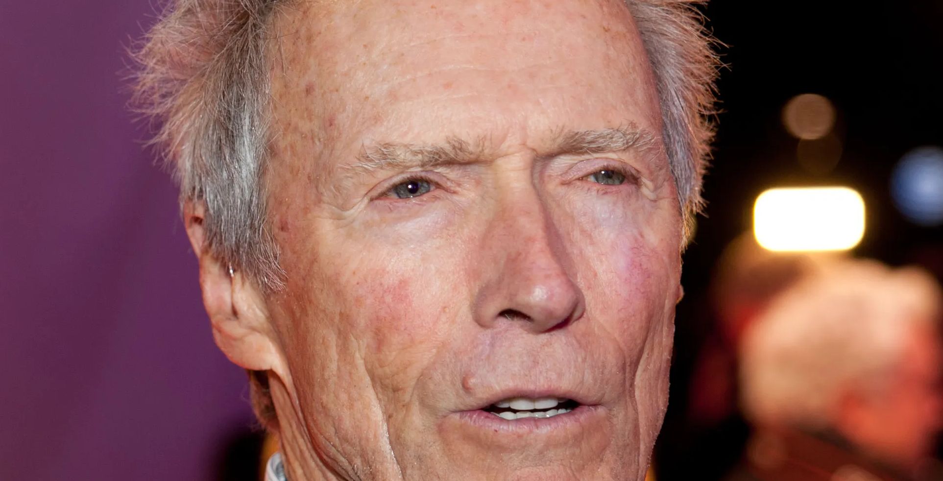 Actor Clint Eastwood looks on.