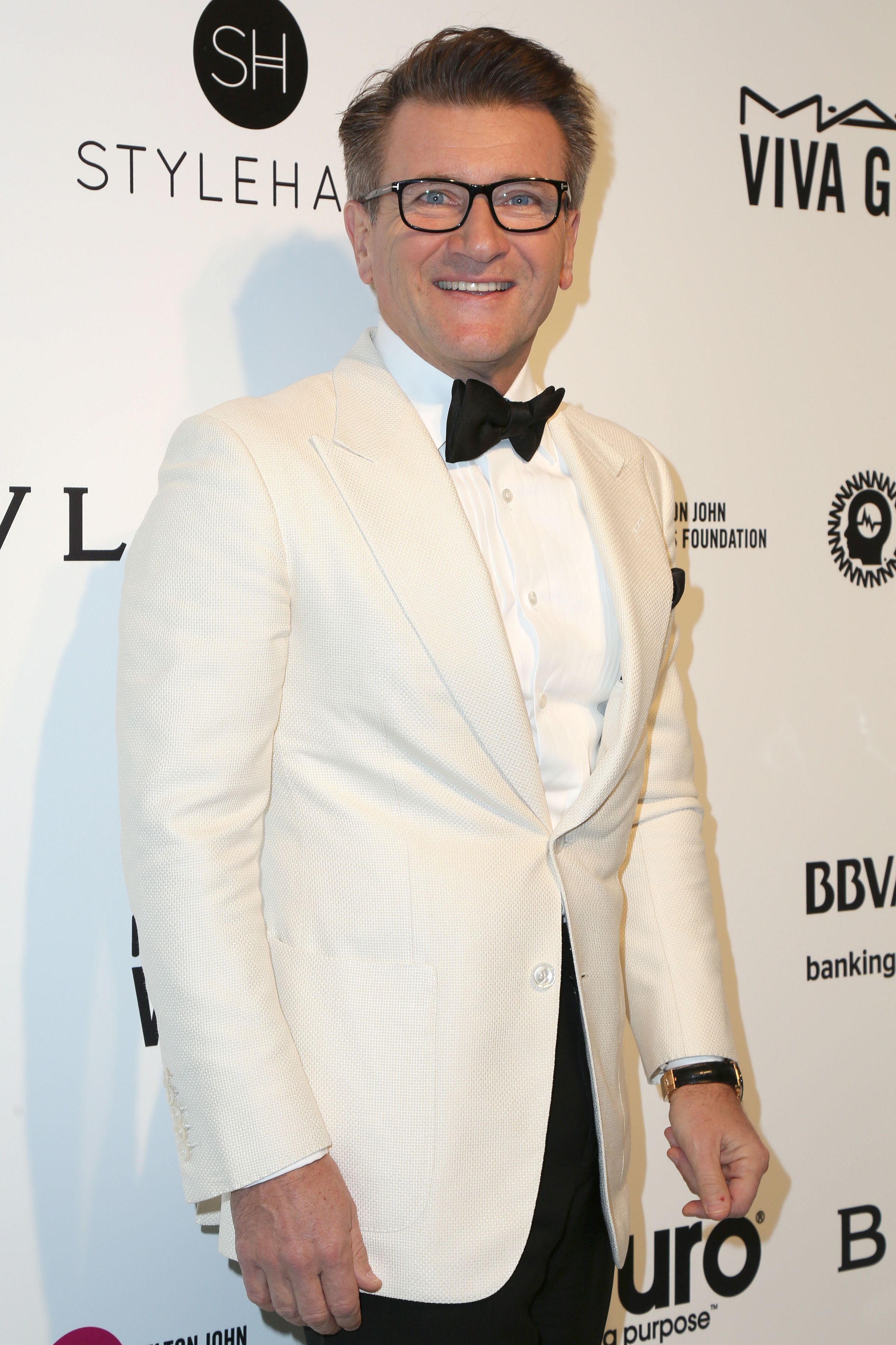 Robert Herjavec wears a white blazer with a black bowtie.