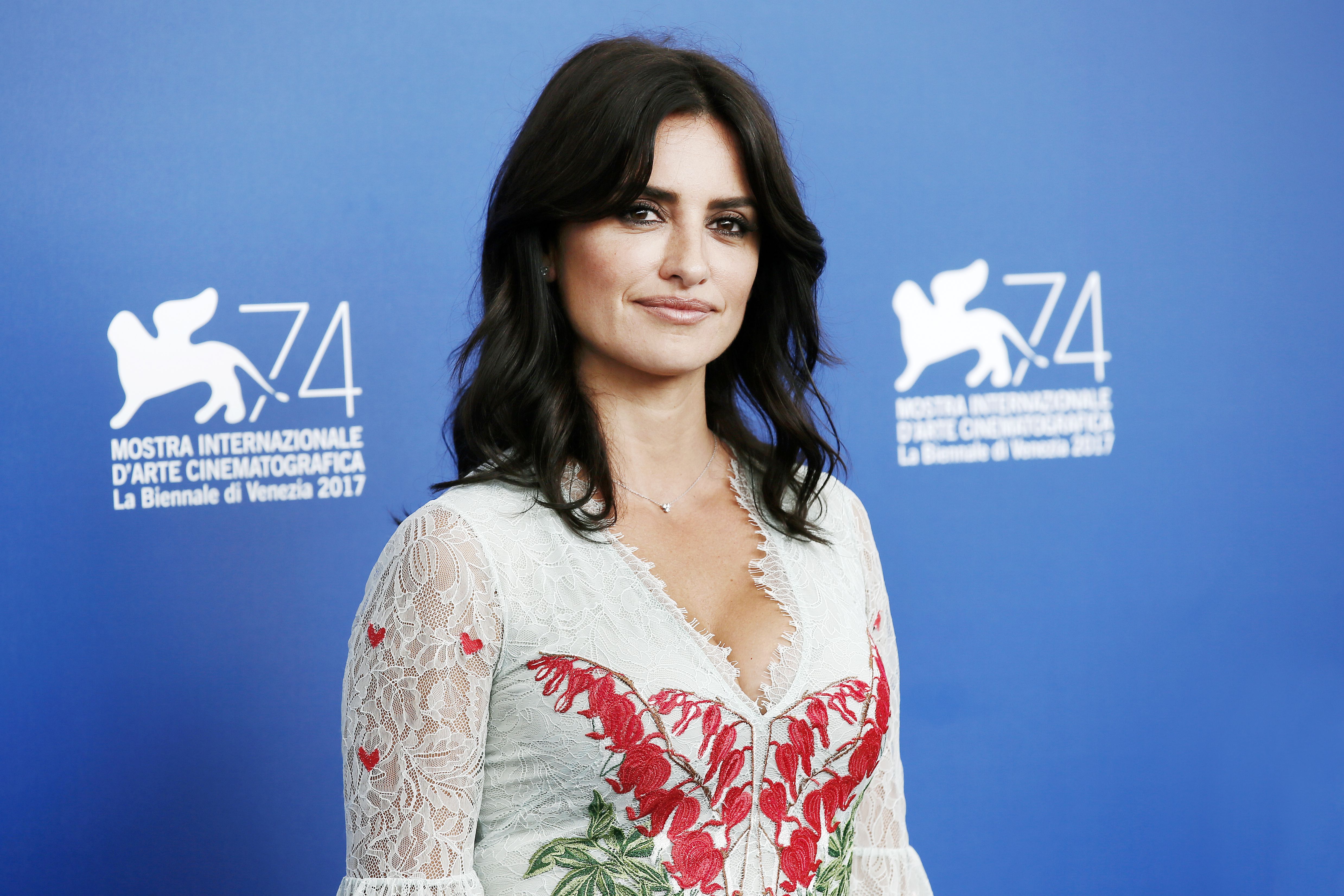 Penelope Cruz wears a white lace top with red and green appliqués.