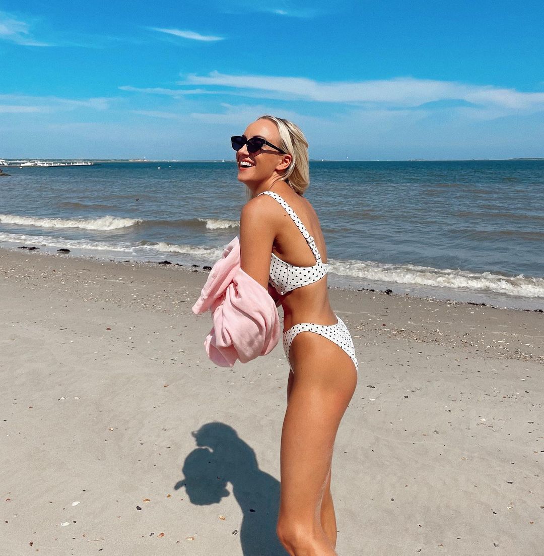 Nastia Liukin poses in white polka-dot bikini at the beach.