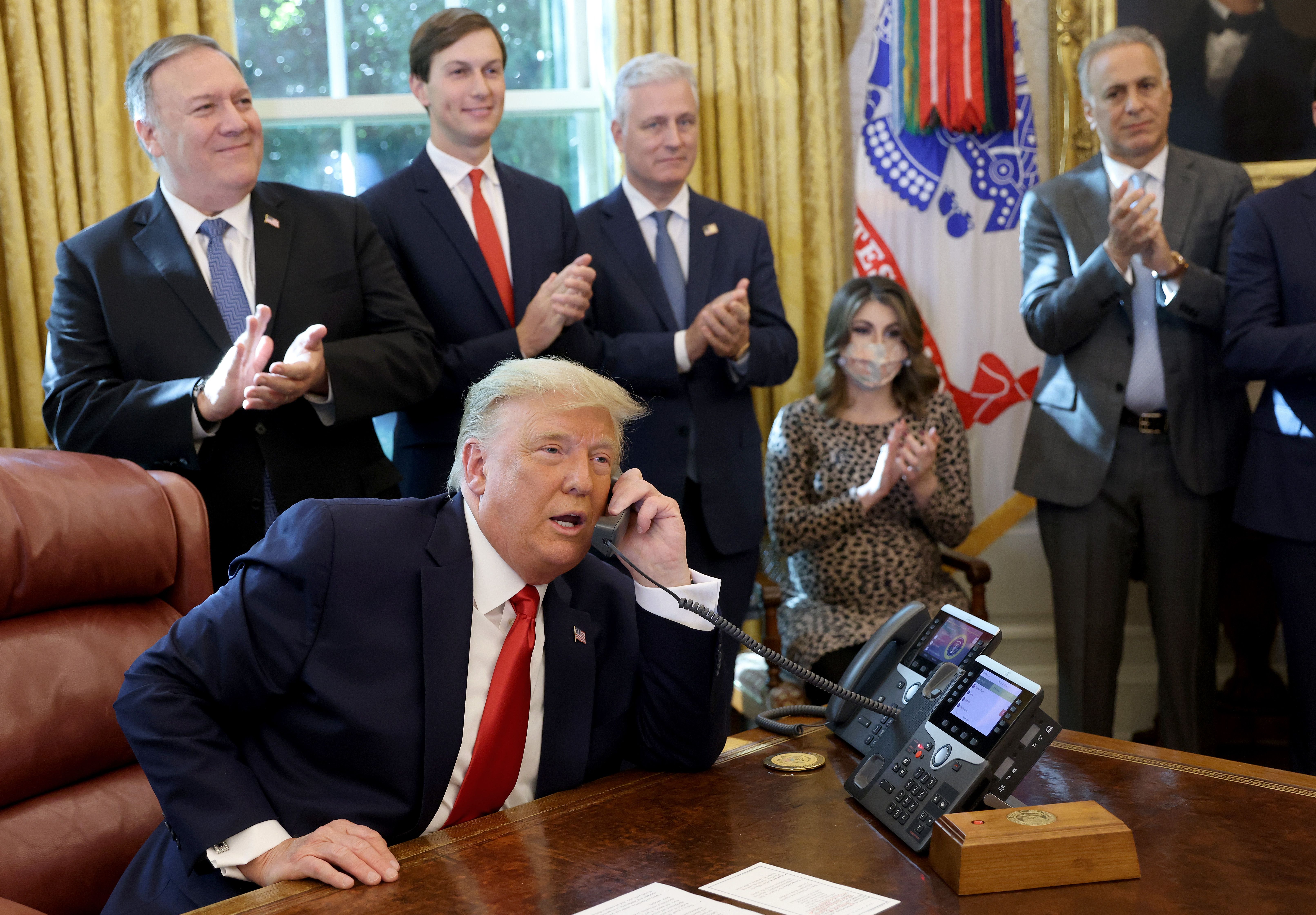 Donald Trump speaks on the phone in the Oval Office.