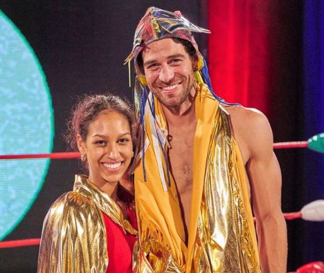 Serena Pitt and Joe Amabile smile in gold capes.