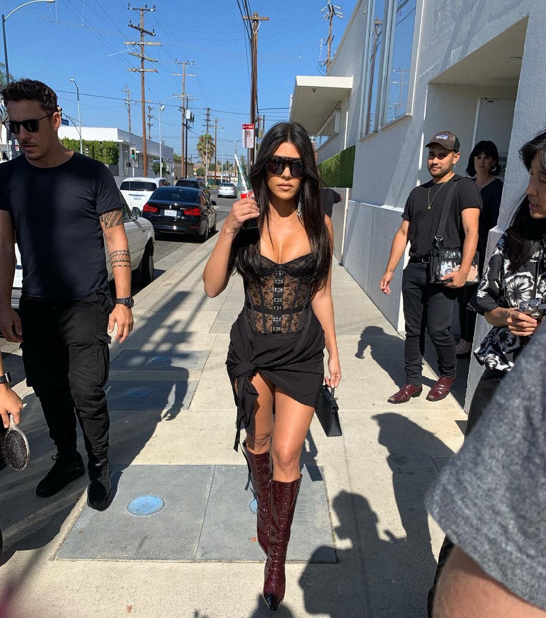Kourtney Kardashian in street with cola