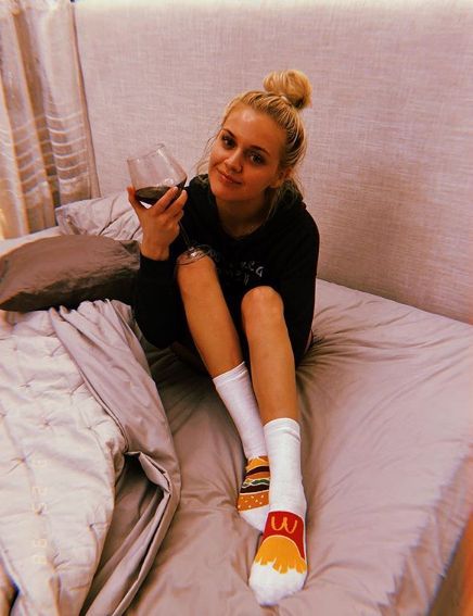 Kelsea Ballerini with wine in bed