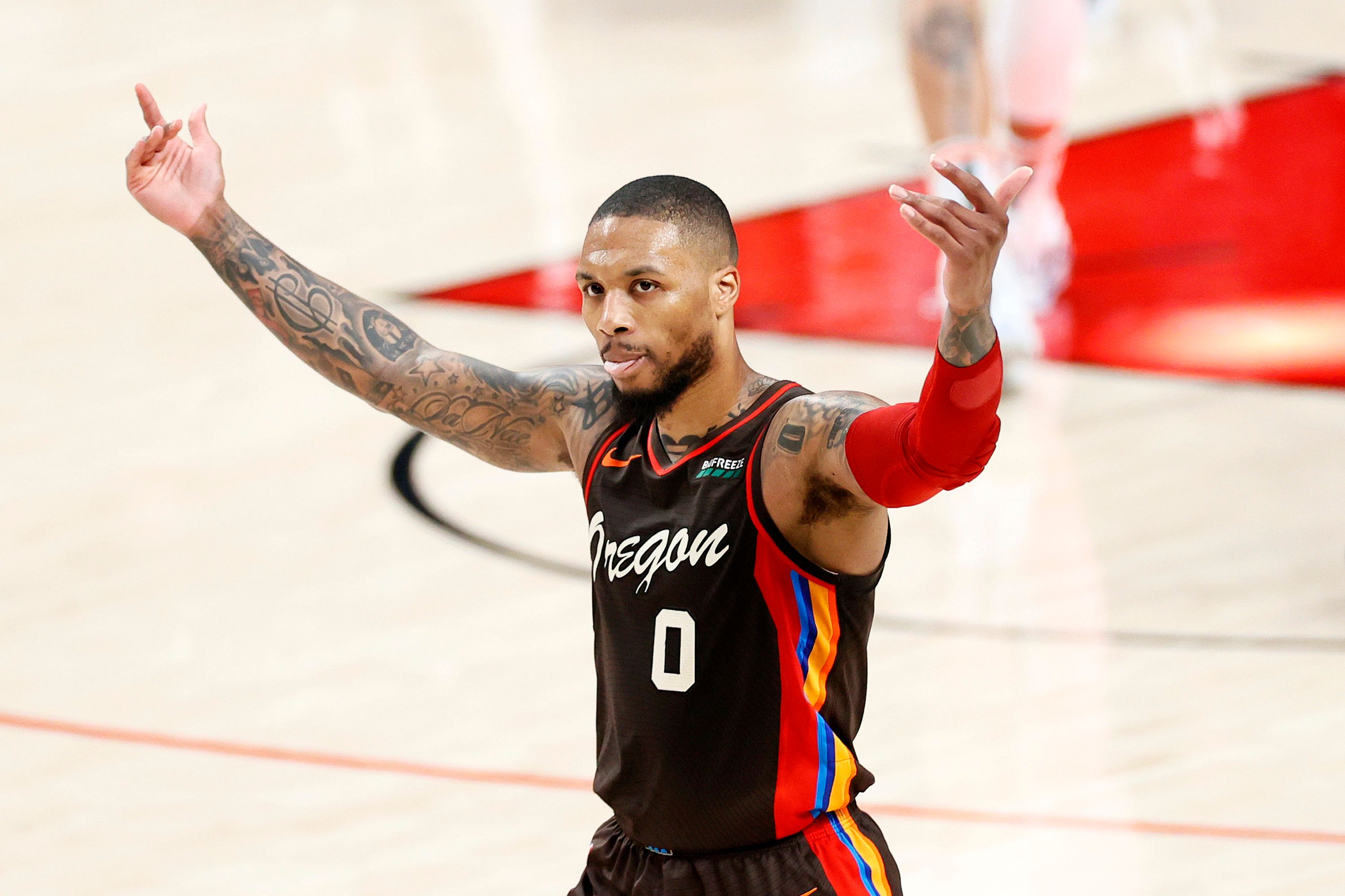 Damian Lillard urging fans to cheer after a successful basket