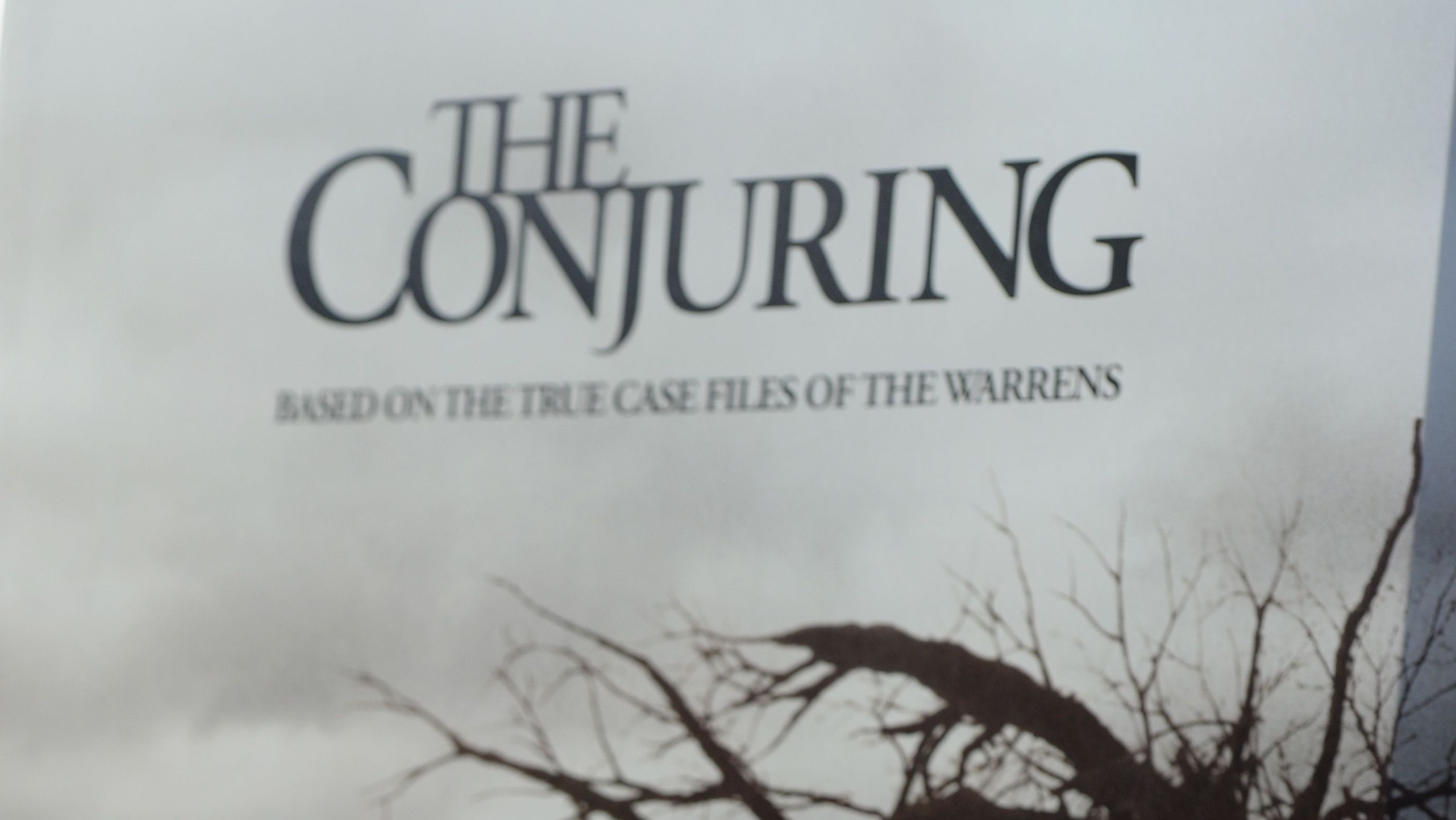 A poster for 'The Conjuring' film.