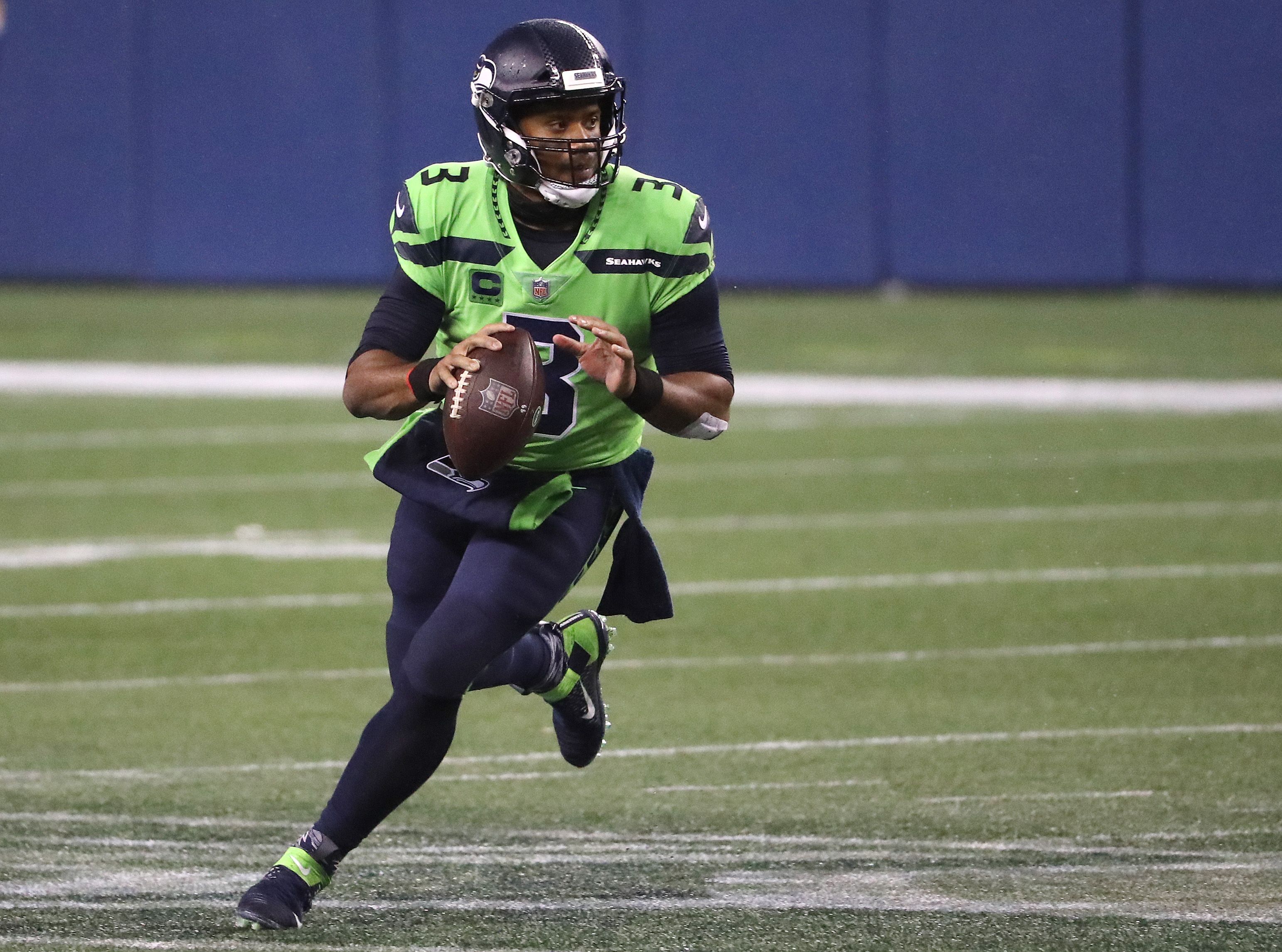 Russell Wilson looks to throw a pass in an NFL game.