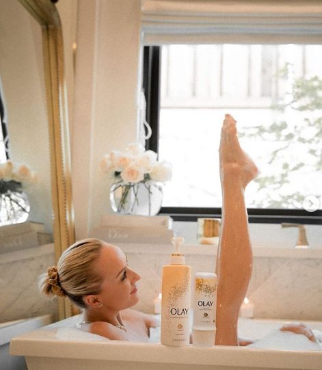 Nastia Liukin poses with feet protruding in a bath