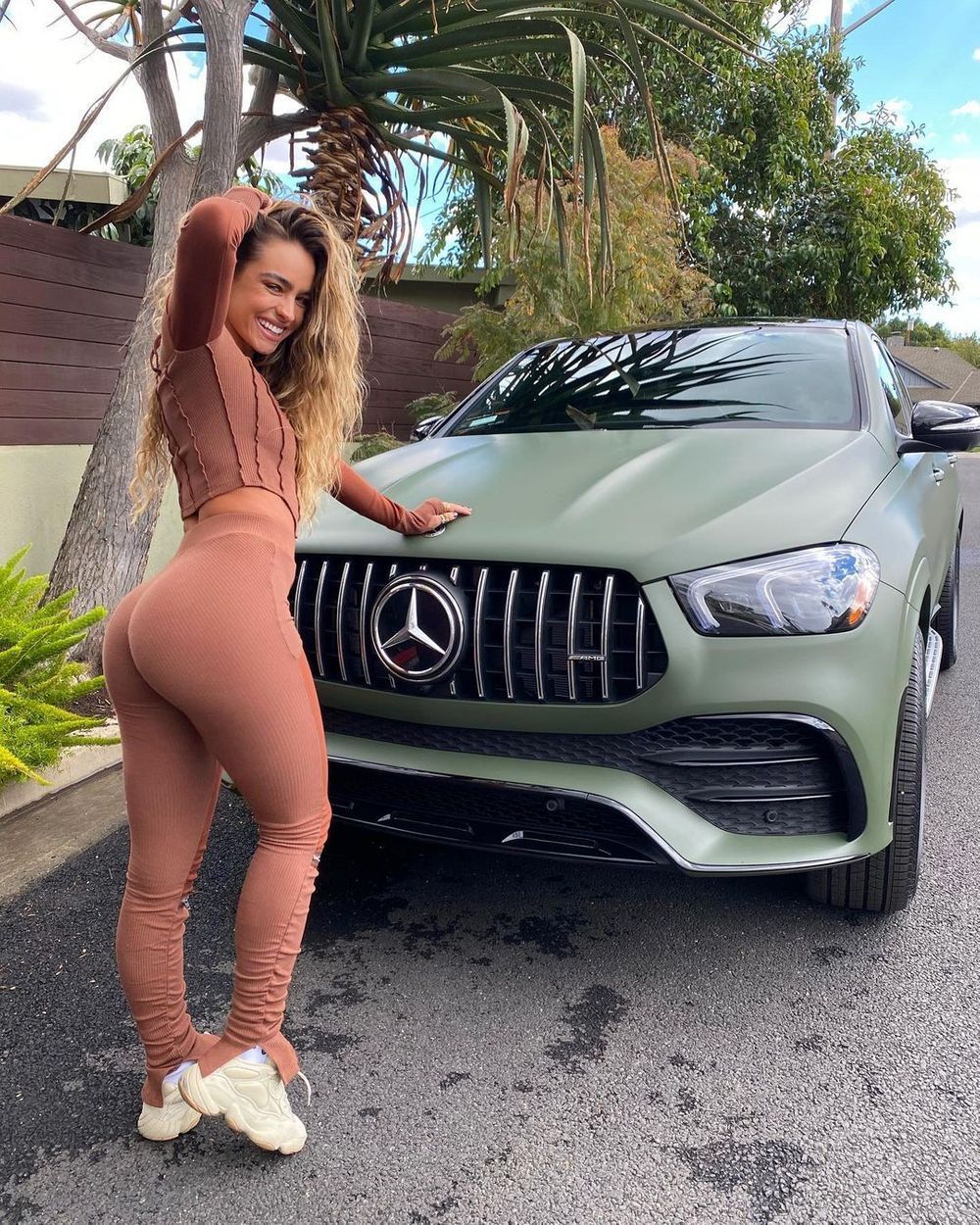 Sommer Ray by a sports car