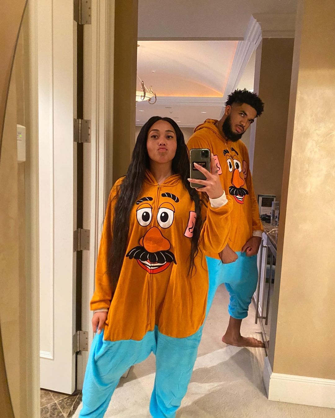Jordyn Woods and Karl Anthony-Towns twin in Mr. Potato Head hoodies and blue sweatpants. 