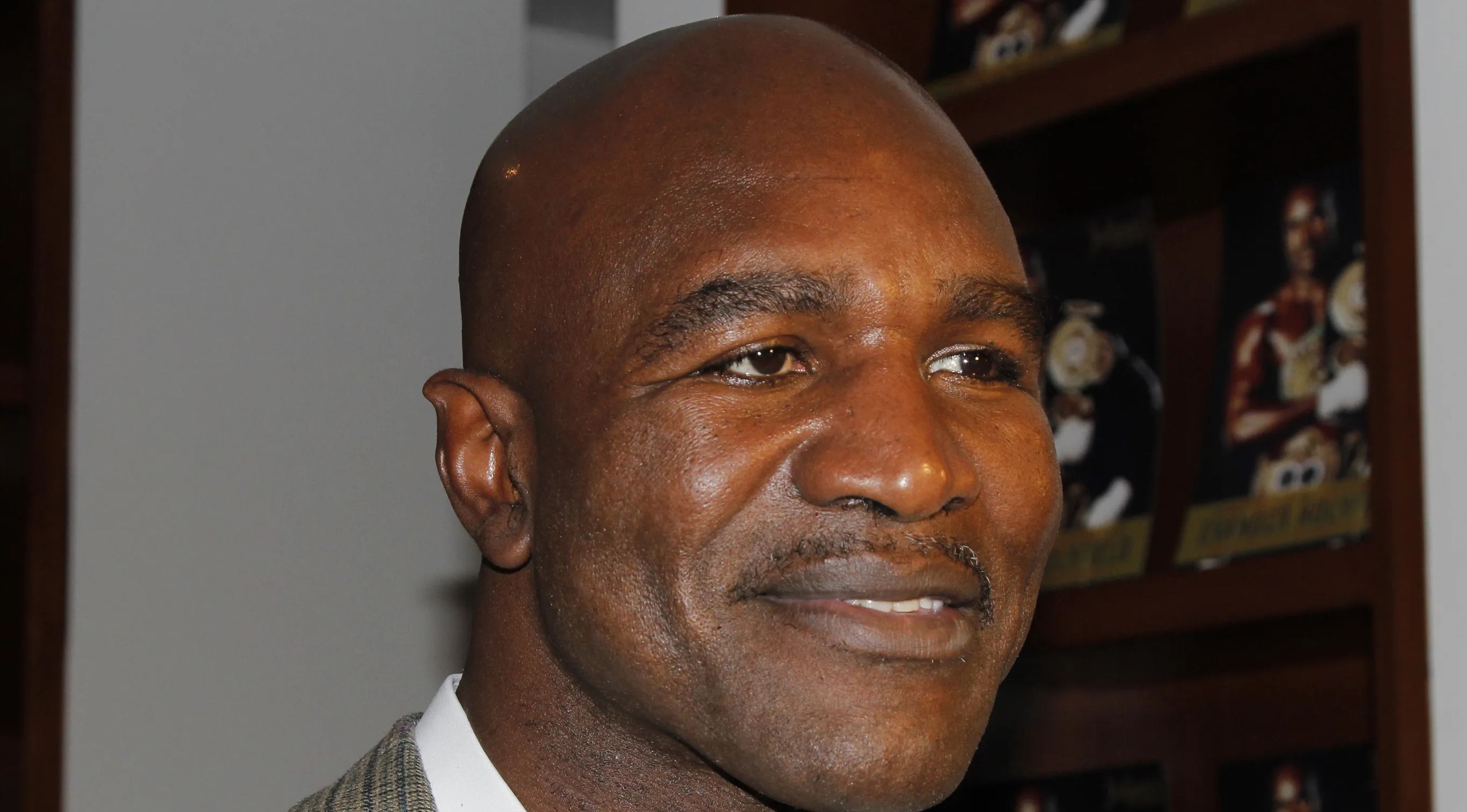 Former boxing champion Evander Holyfield looks on.