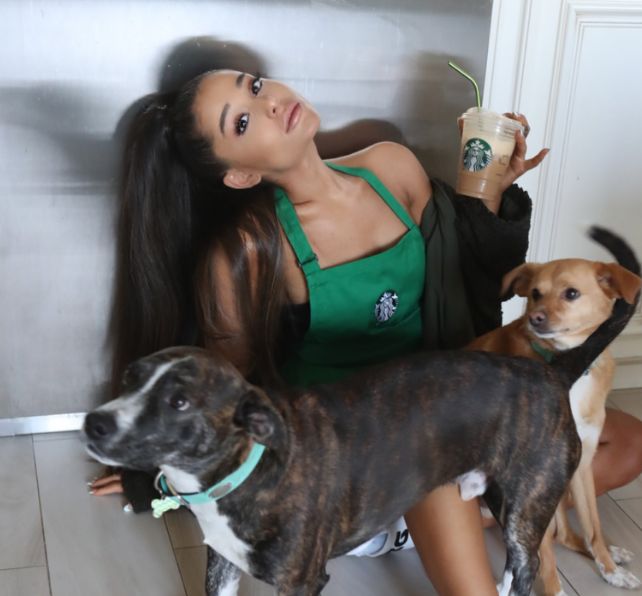 Ariana Grande poses with a Starbucks drink