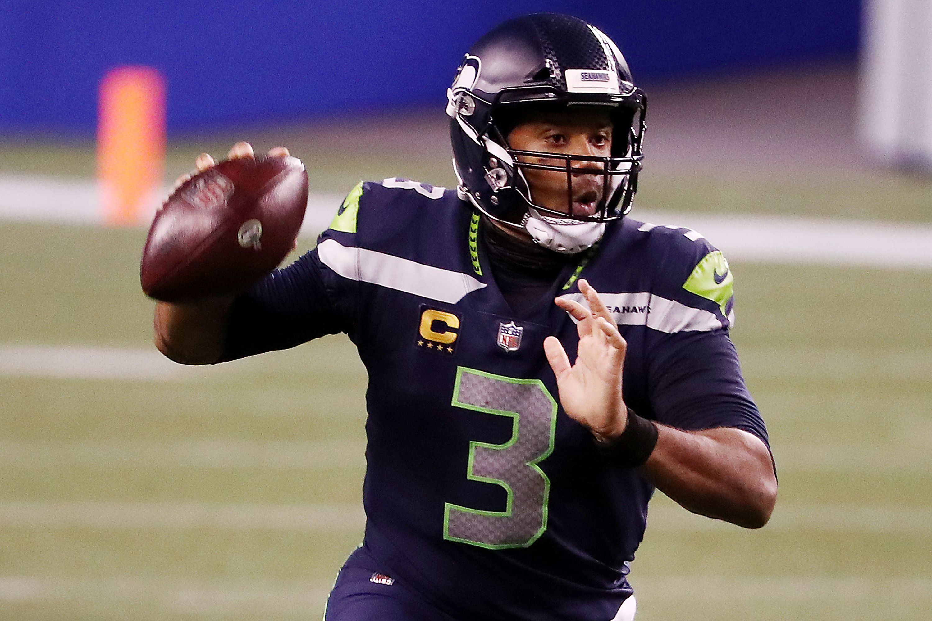 Russell Wilson prepares to throw a pass in an NFL game.