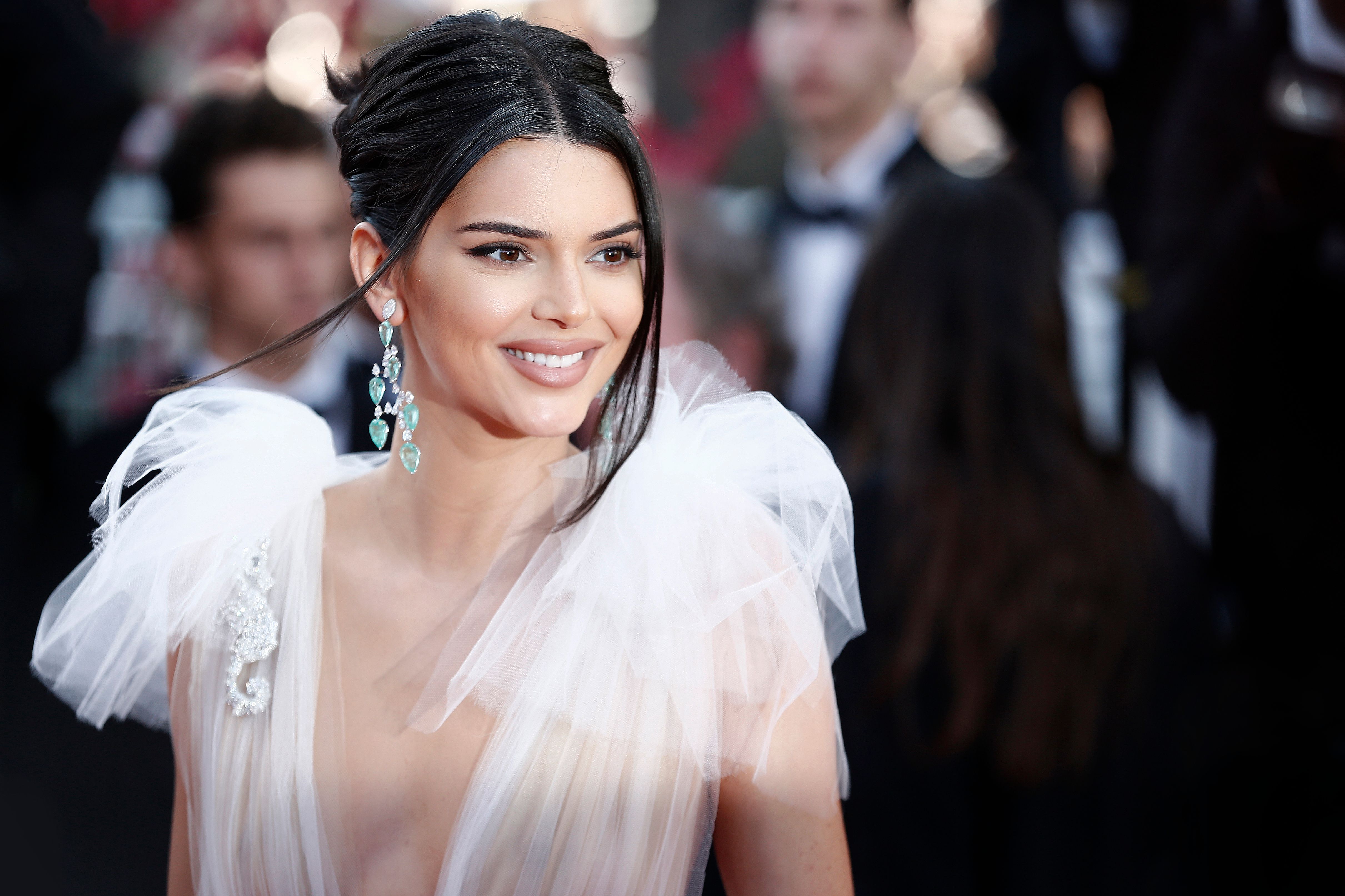 Kendall Jenner wears plunging white tulle dress at an event.