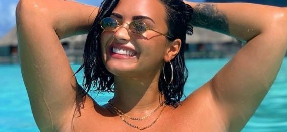Demi Lovato smiles in a pool