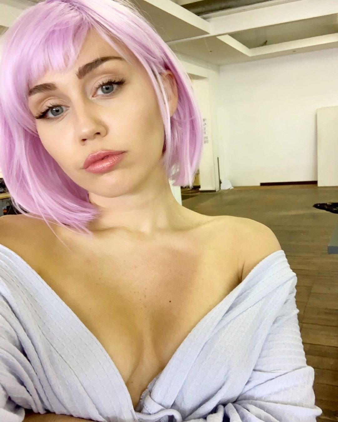 Miley Cyrus in robe and wig