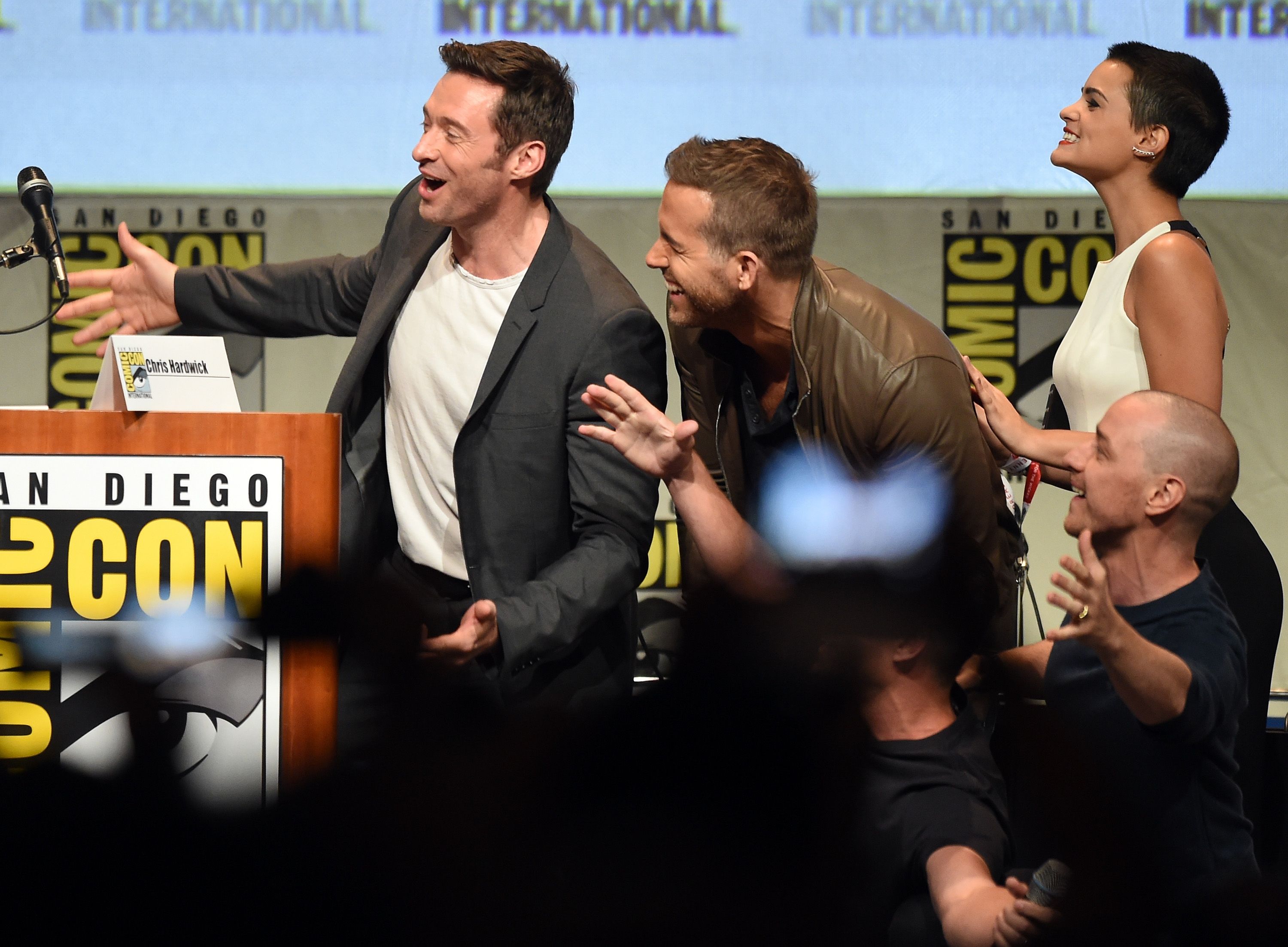 Hugh Jackman and Ryan Reynolds laugh at Comic Con.