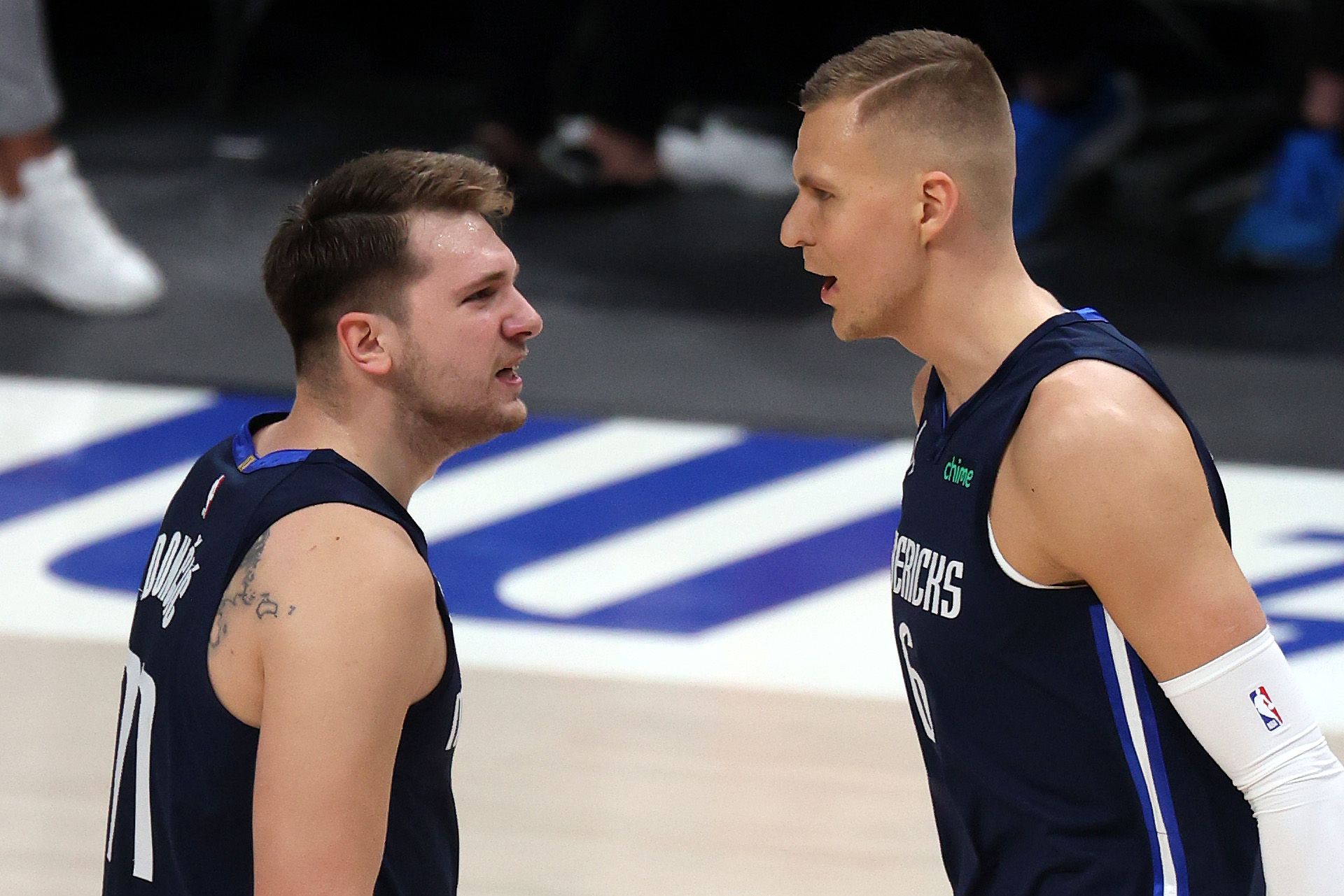 Luka Doncic and Kristaps Porzingis bump body after a successful play