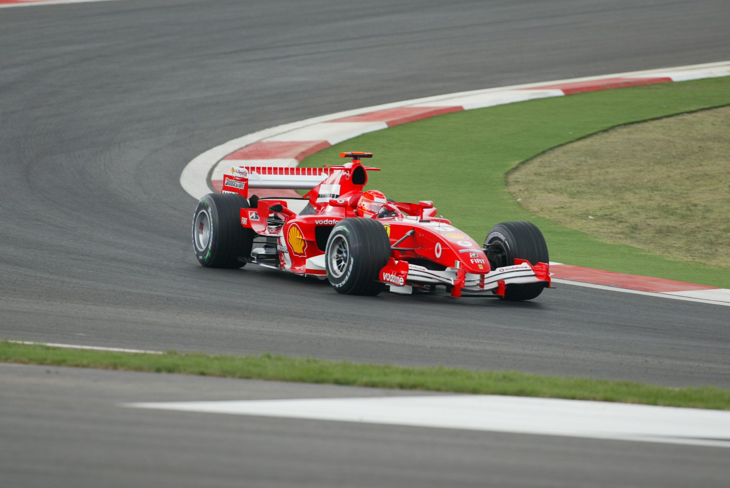 Michael Schumacher drives red race car.
