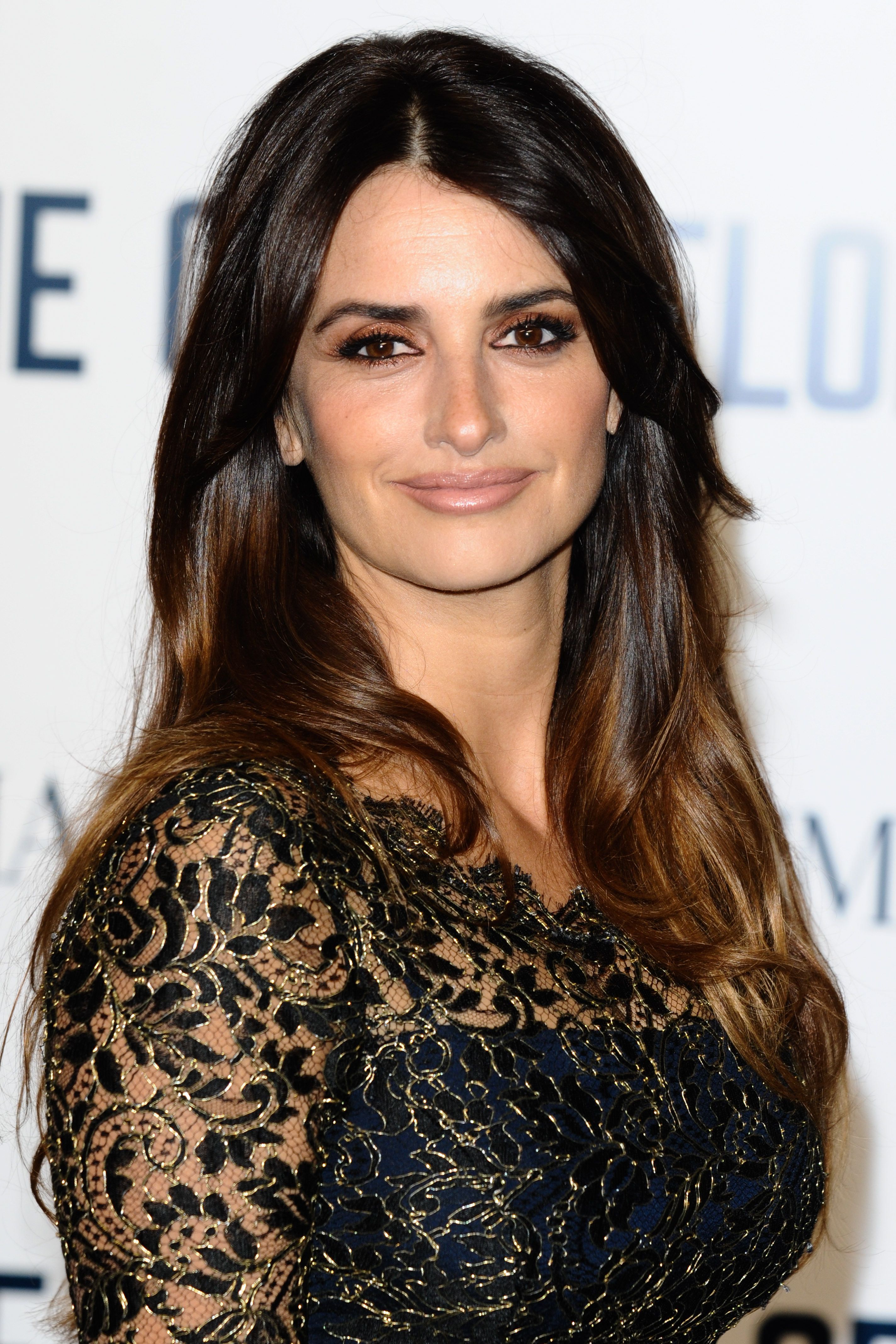 Penelope Cruz wears a lace dress with her hair down.