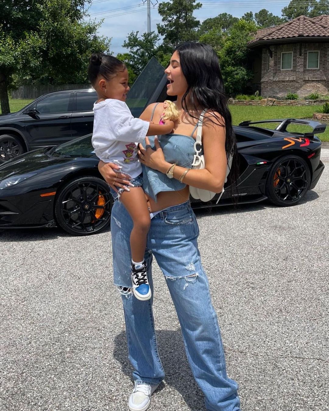 Kylie Jenner holding Stormi outdoors