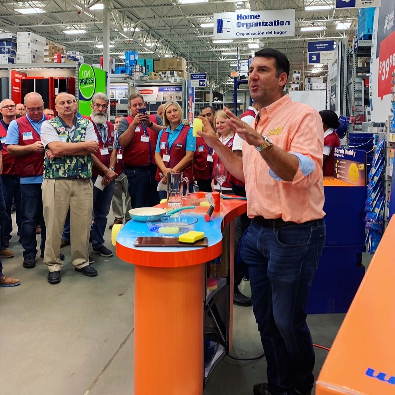 Scrub Daddy exec talks about product with store staff.