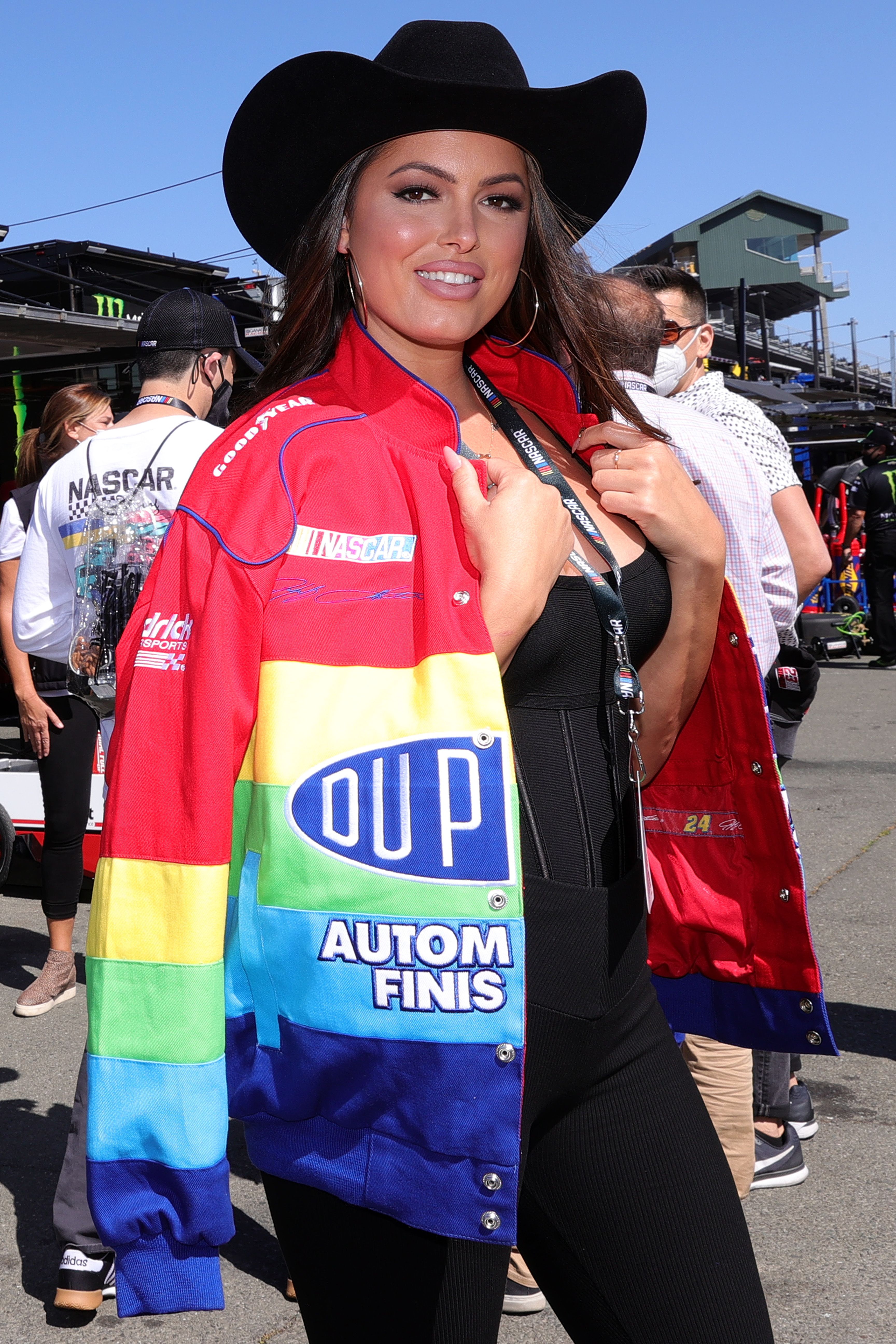 Constance Nunes wears a rainbow jacket and cowboy hat.