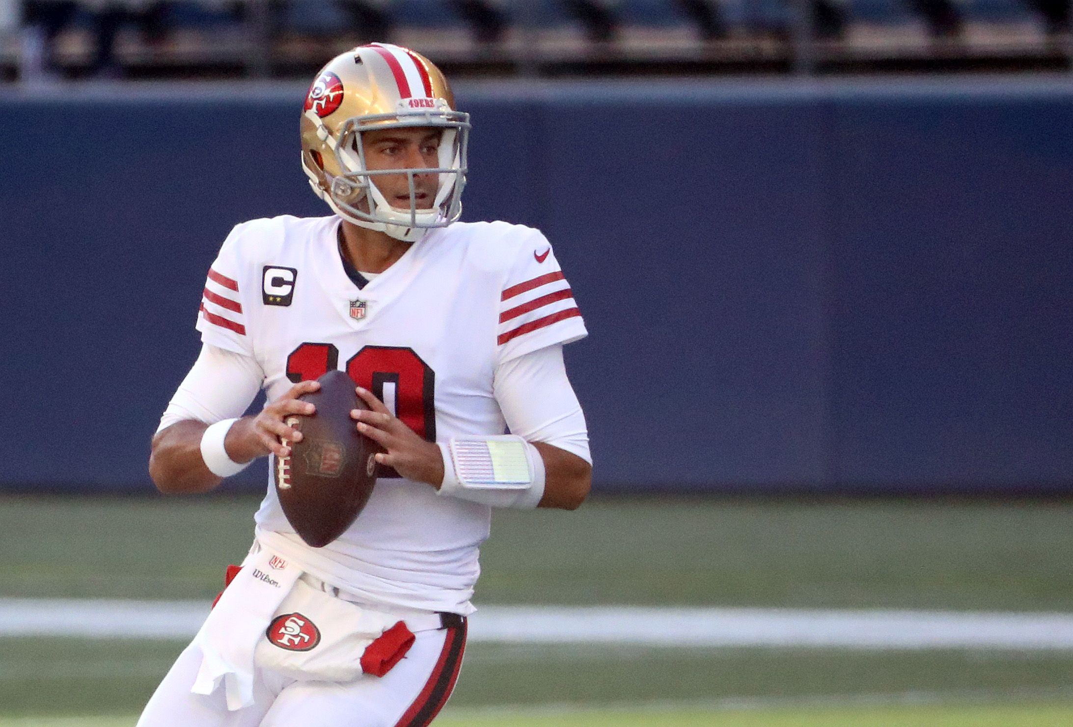 Jimmy Garoppolo prepares to throw a pass in an NFL game.