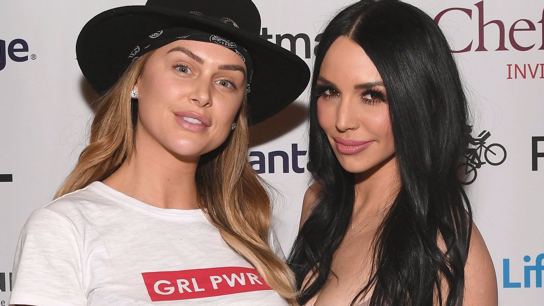 Lala Kent wears a 'GRL PWR' T-shirt and hat next to Scheana Shay.