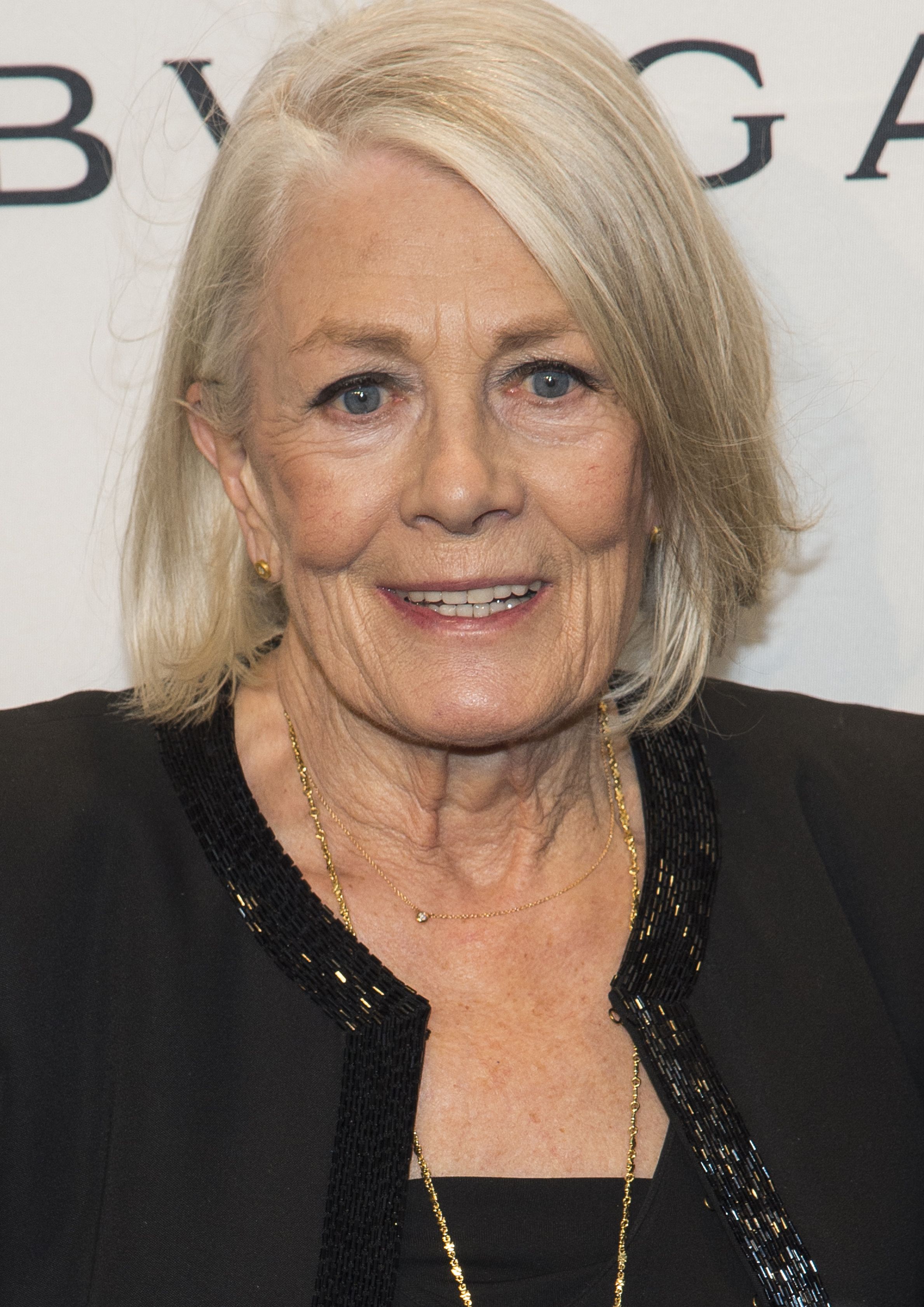 Vanessa Redgrave wears black with gold necklace.