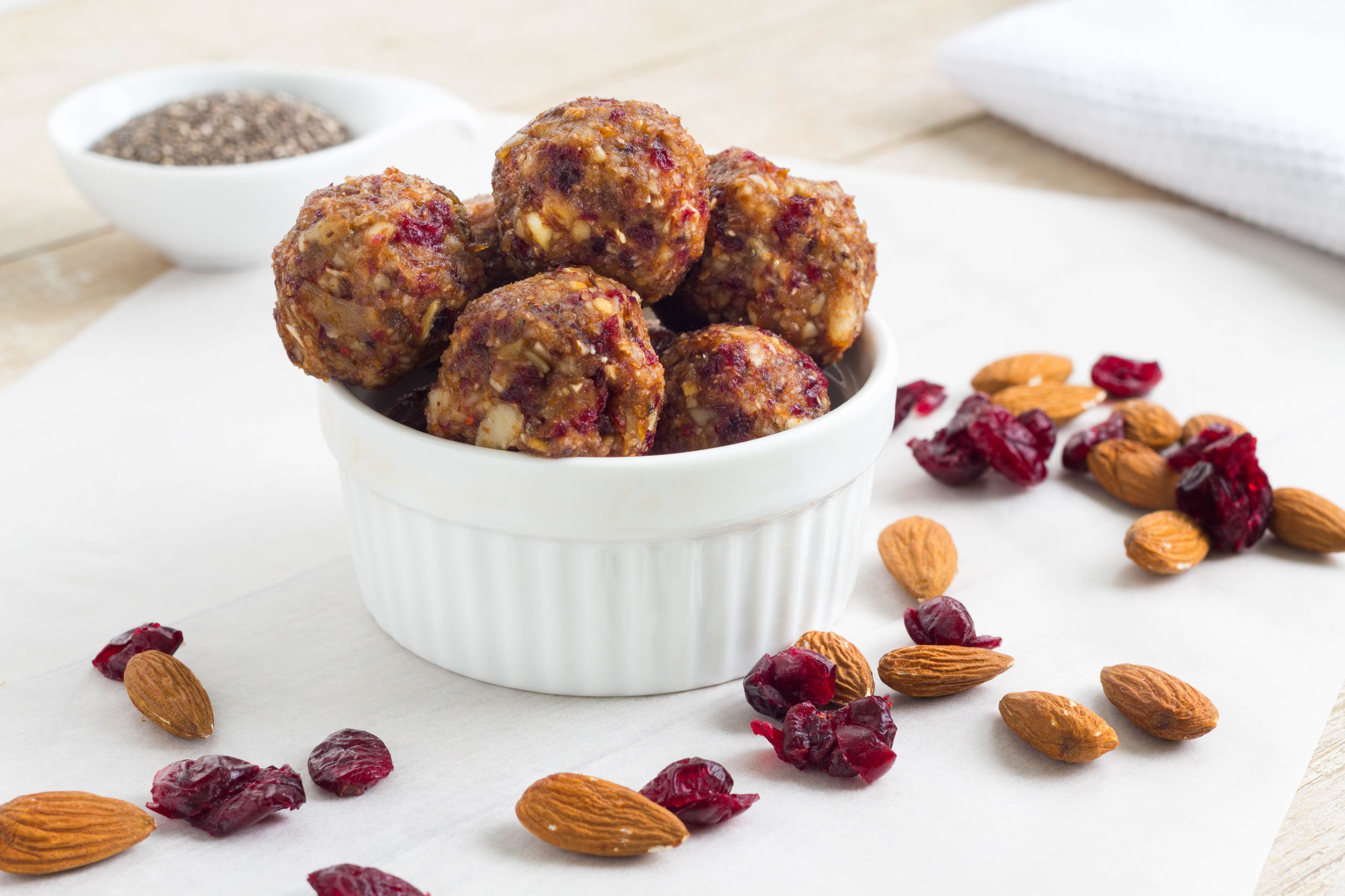 Protein power balls in a bowl, with almonds and dried fruit. 
