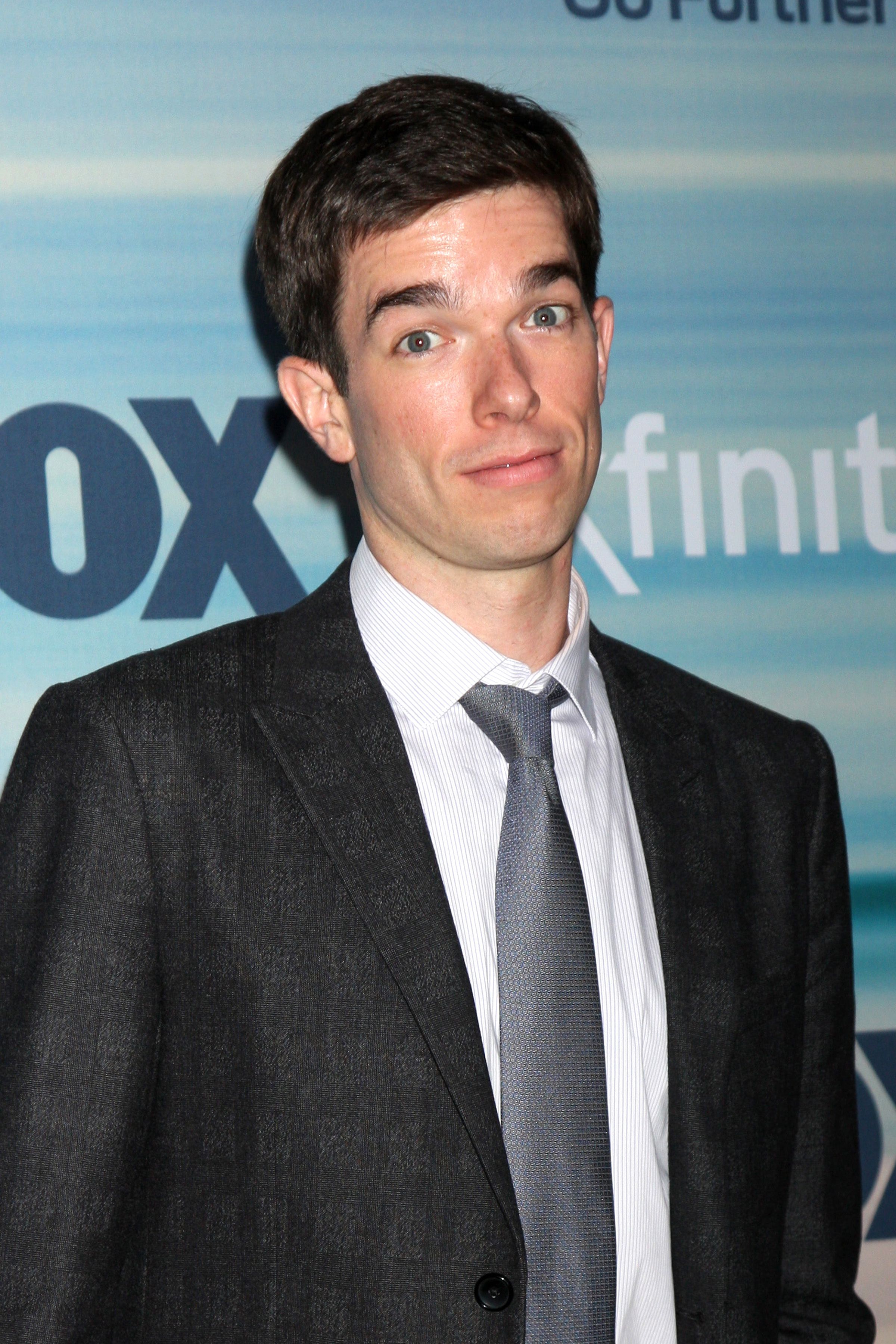 John Mulaney in suit and tie