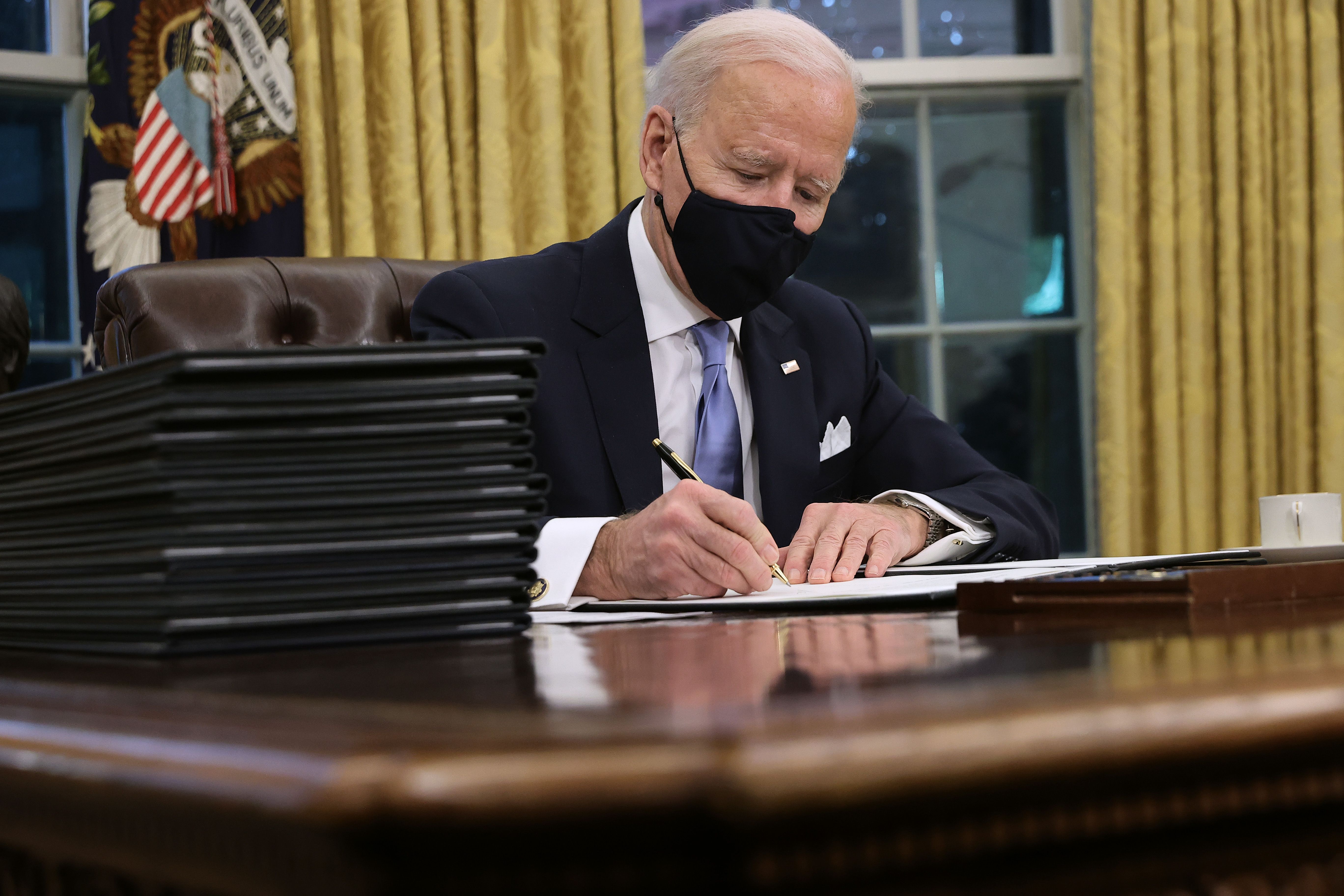 Joe Biden signs an executive order.
