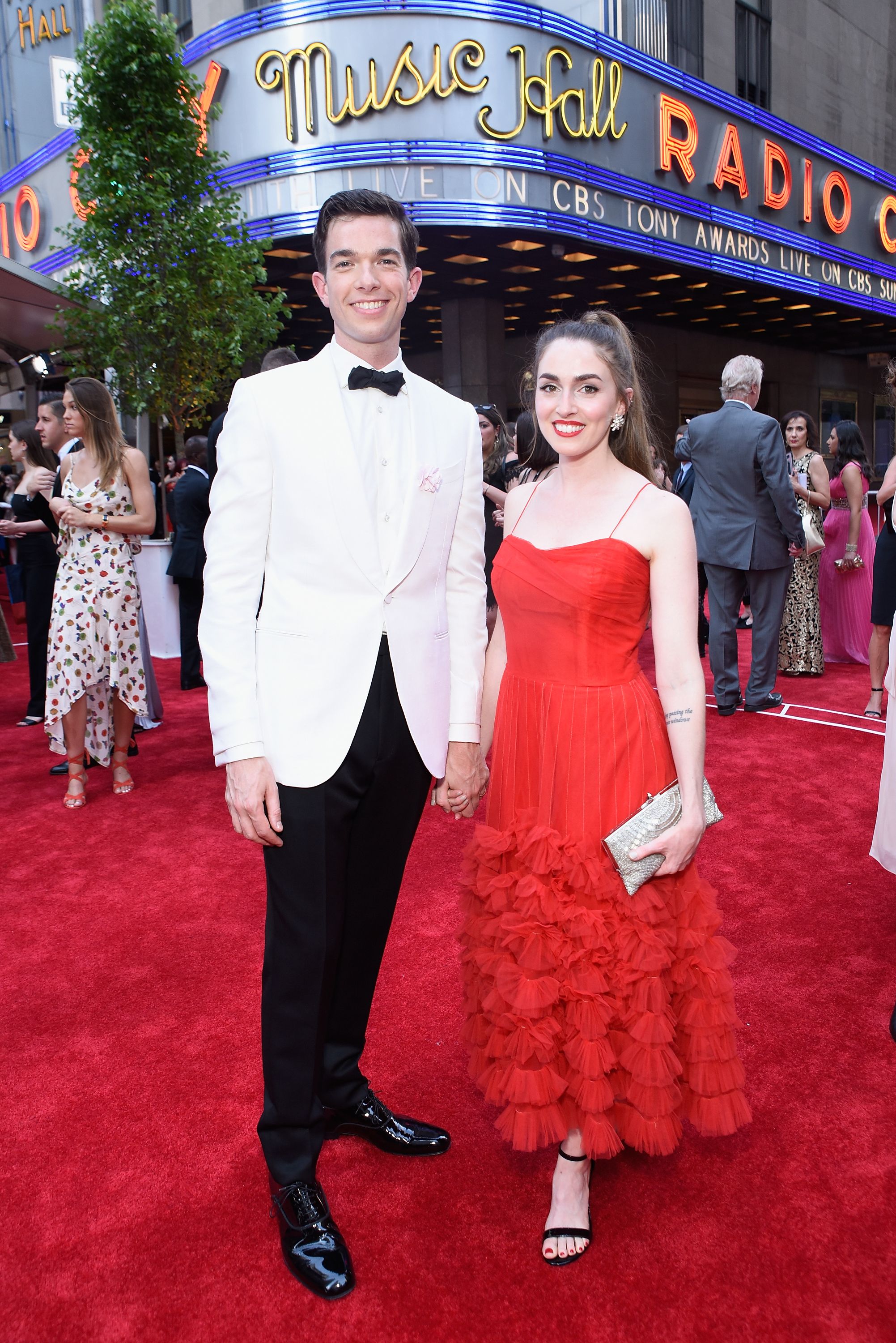 John Mulaney and Anna Marie Tendler pose on red carpet outside Radio City Music Hall
