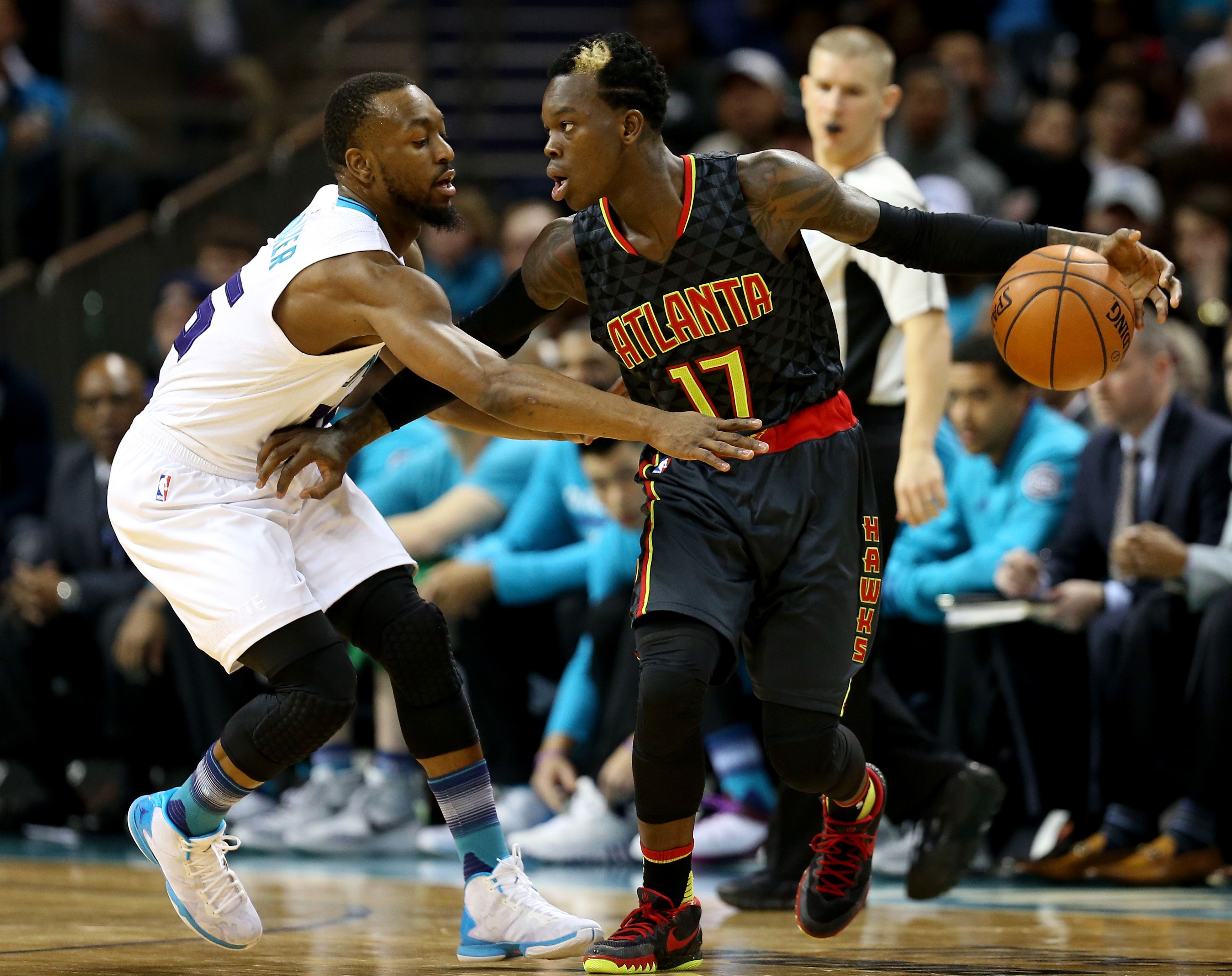 Kemba Walker trying to take the ball from Dennis Schroder