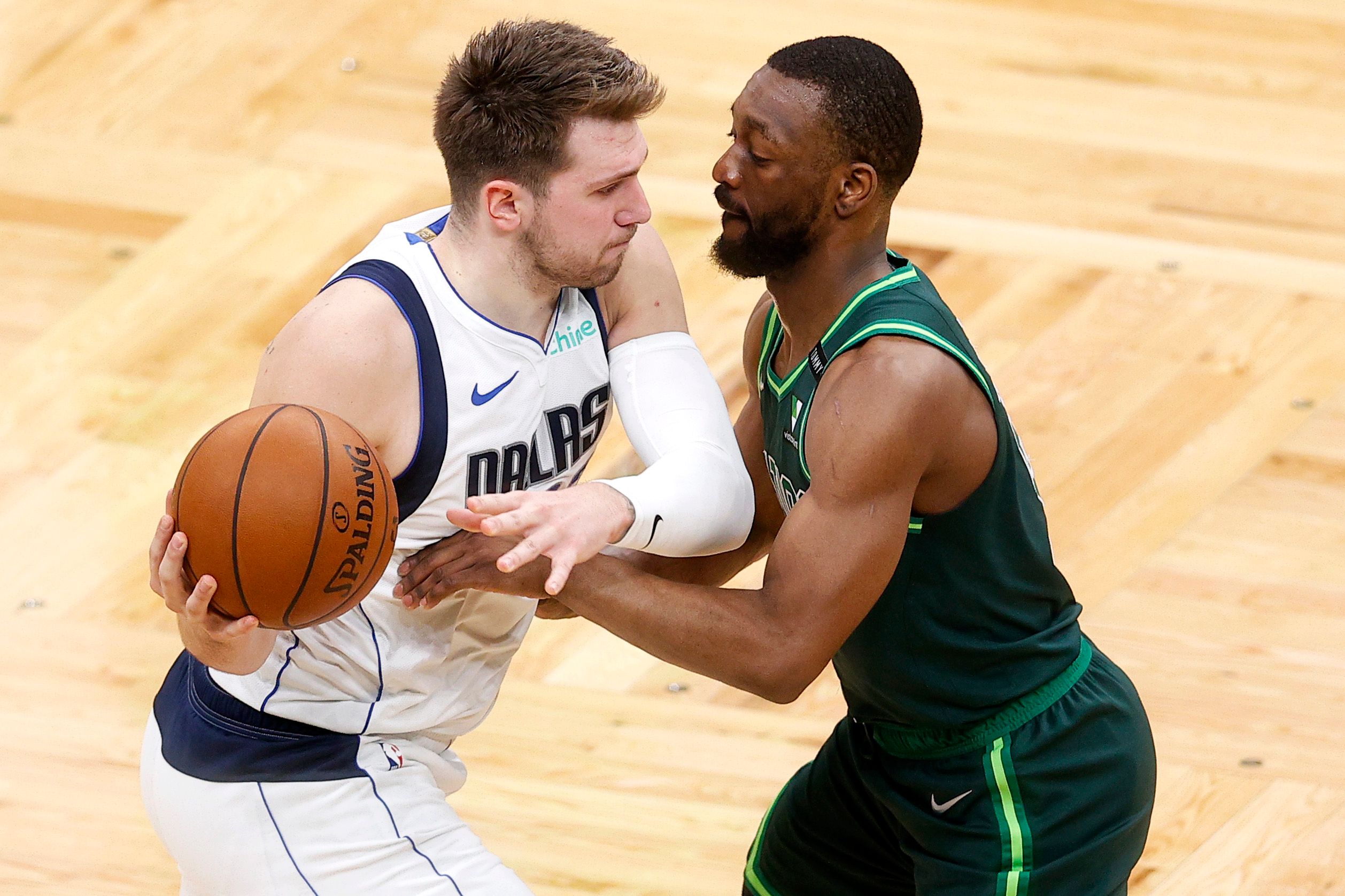 Kemba Walker trying to steal the ball from Luka Doncic
