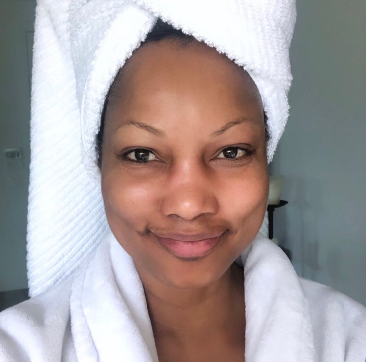 Garcelle Beauvais poses with her hair in a towel.