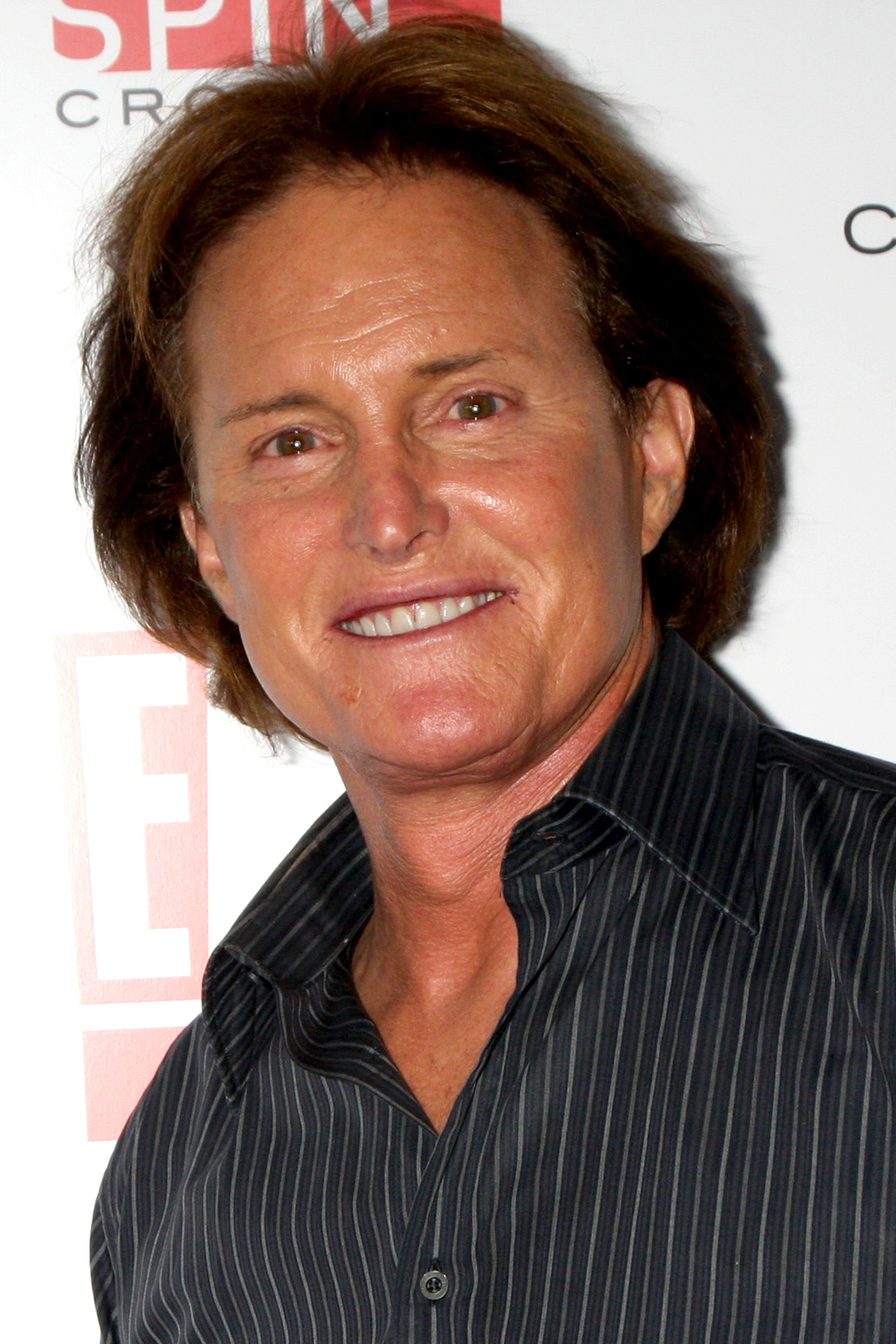  Bruce Jenner wears a striped button-up.