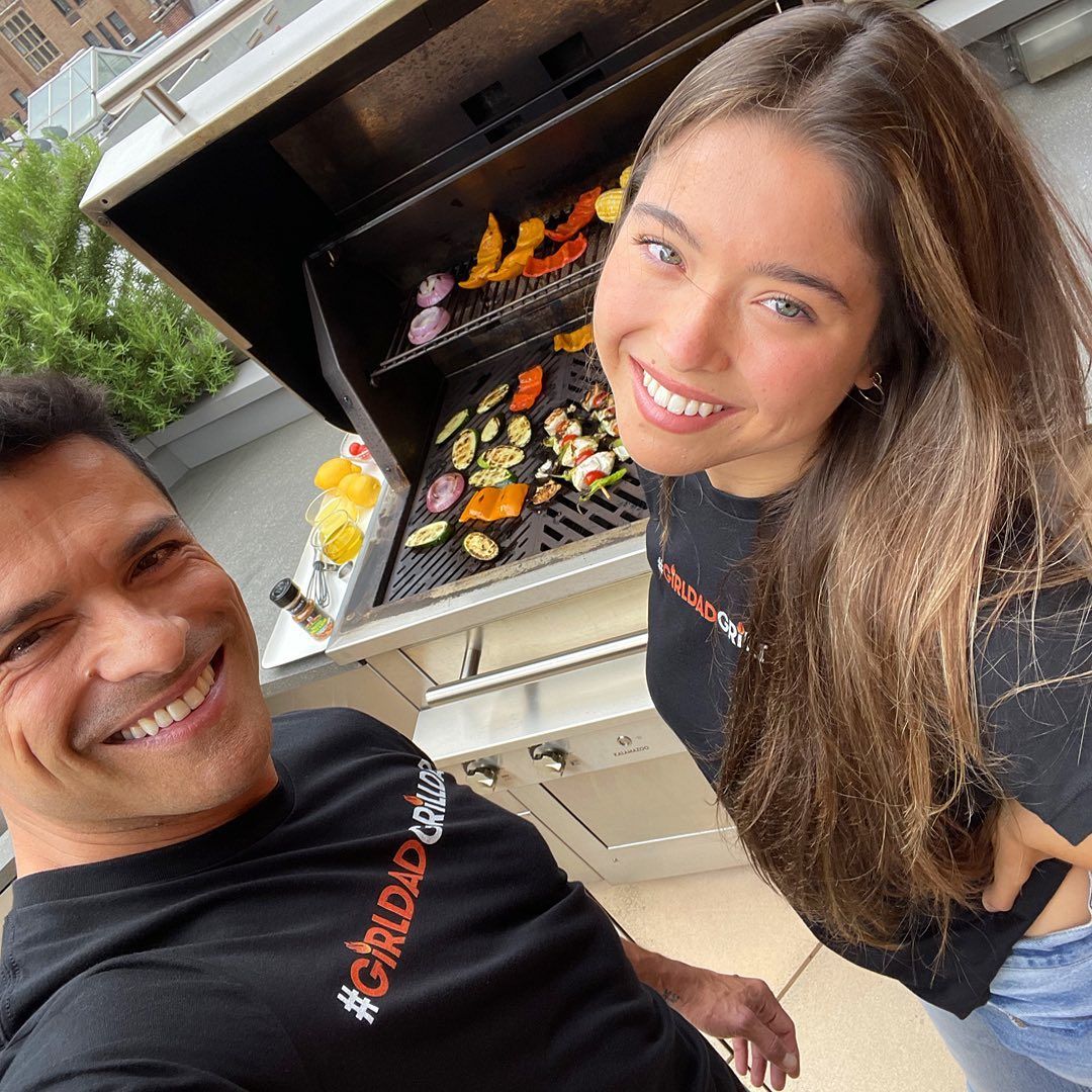 Mark Consuelos and Lola grilling on a terrace