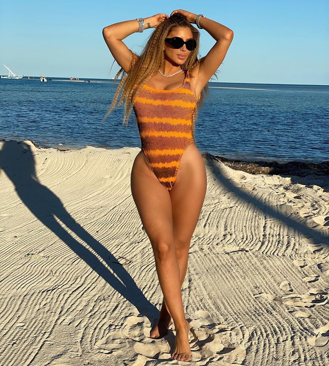 Larsa Pippen poses on the beach in a swimsuit