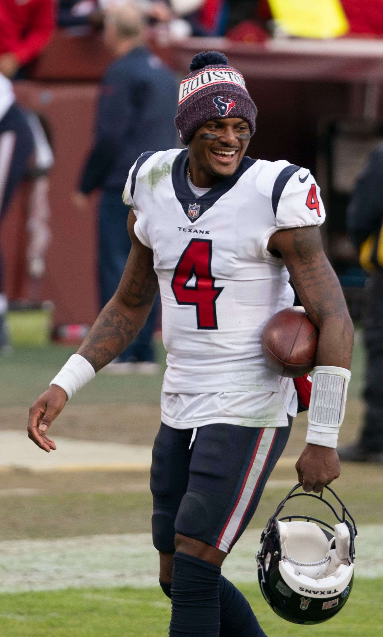 Deshaun Watson smiling while carrying his helmet and football