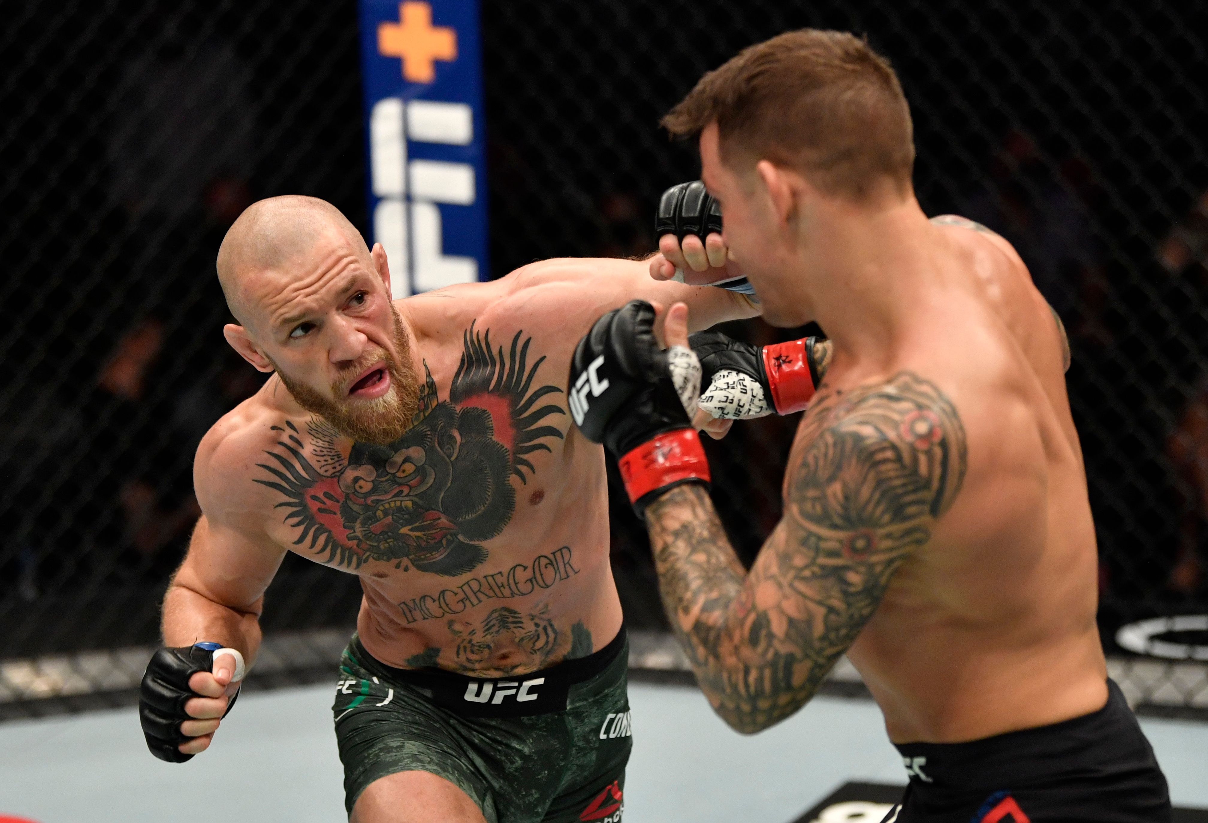 Conor McGregor punches Dustin Poirier during their January fight.