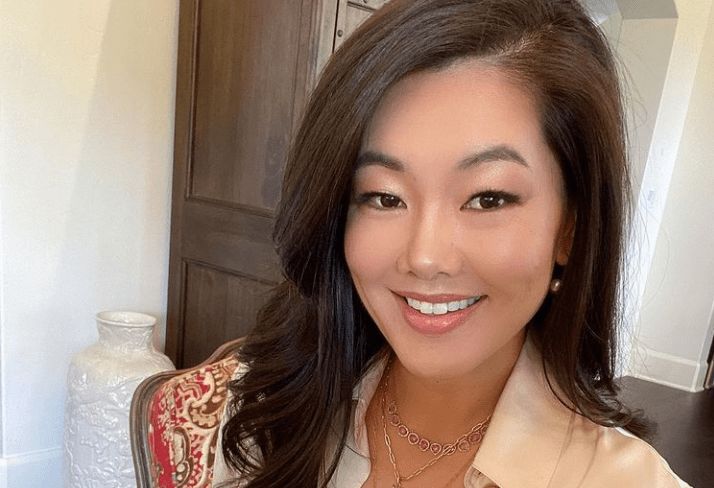 Crystal Kung-Minkoff wears a beige button-up and smiles.