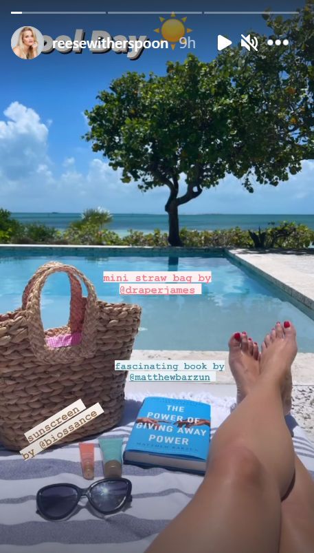 Reese Witherspoon lounging poolside with her summer essentials.