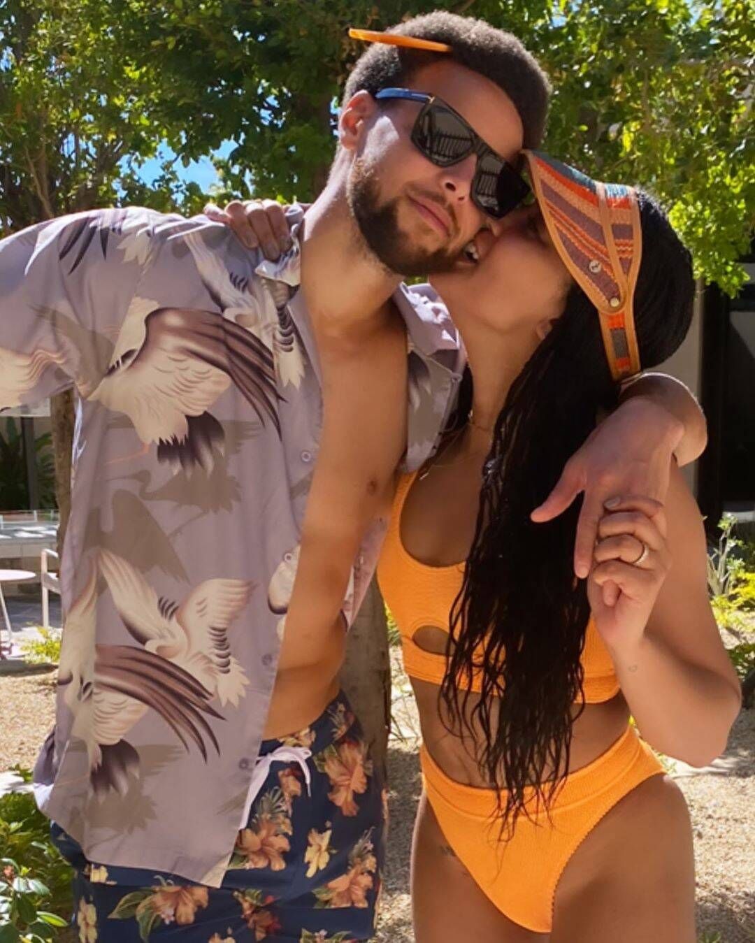 Steph and Ayesha in swimwear kiss