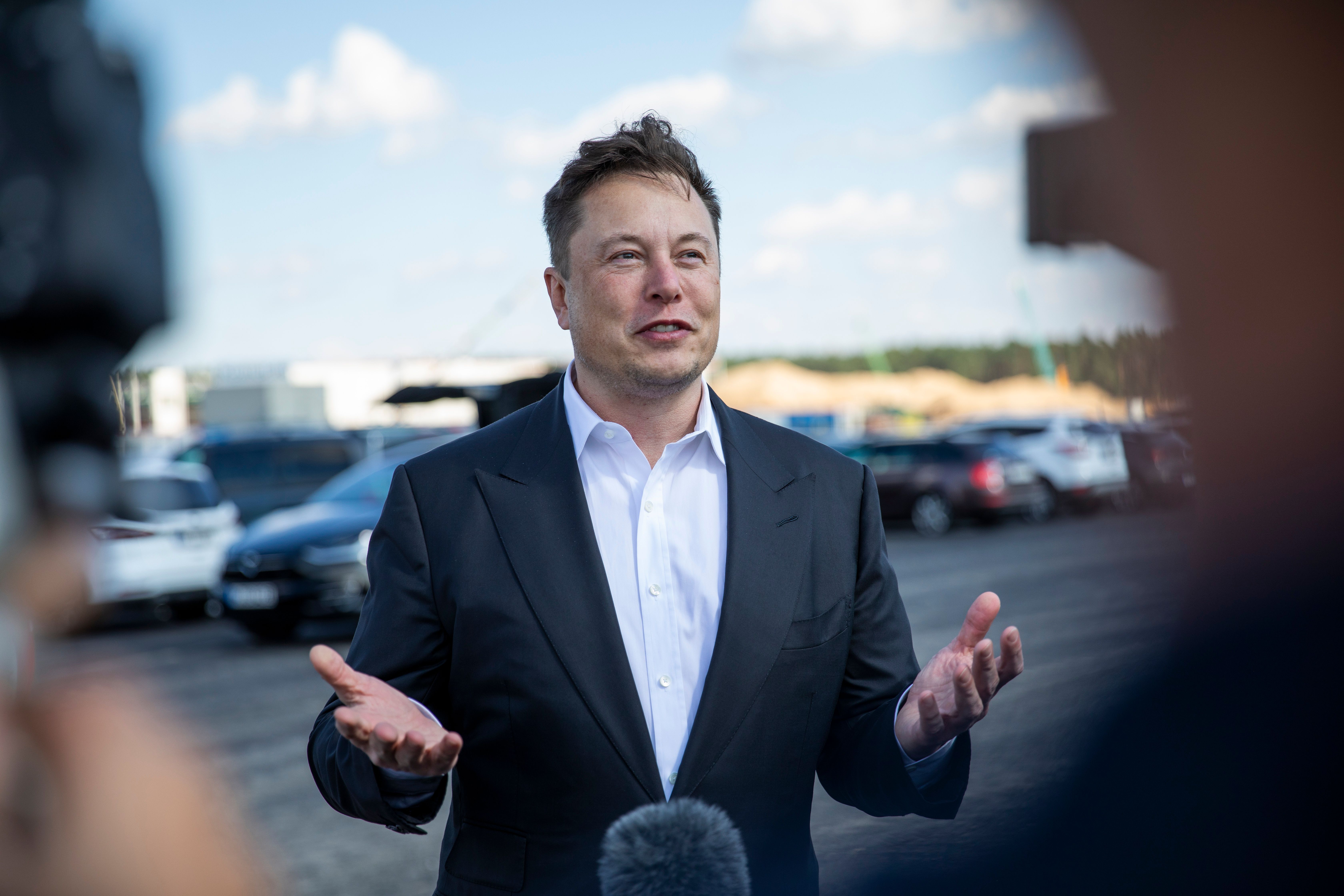 Elon Musk speaks to reporters.