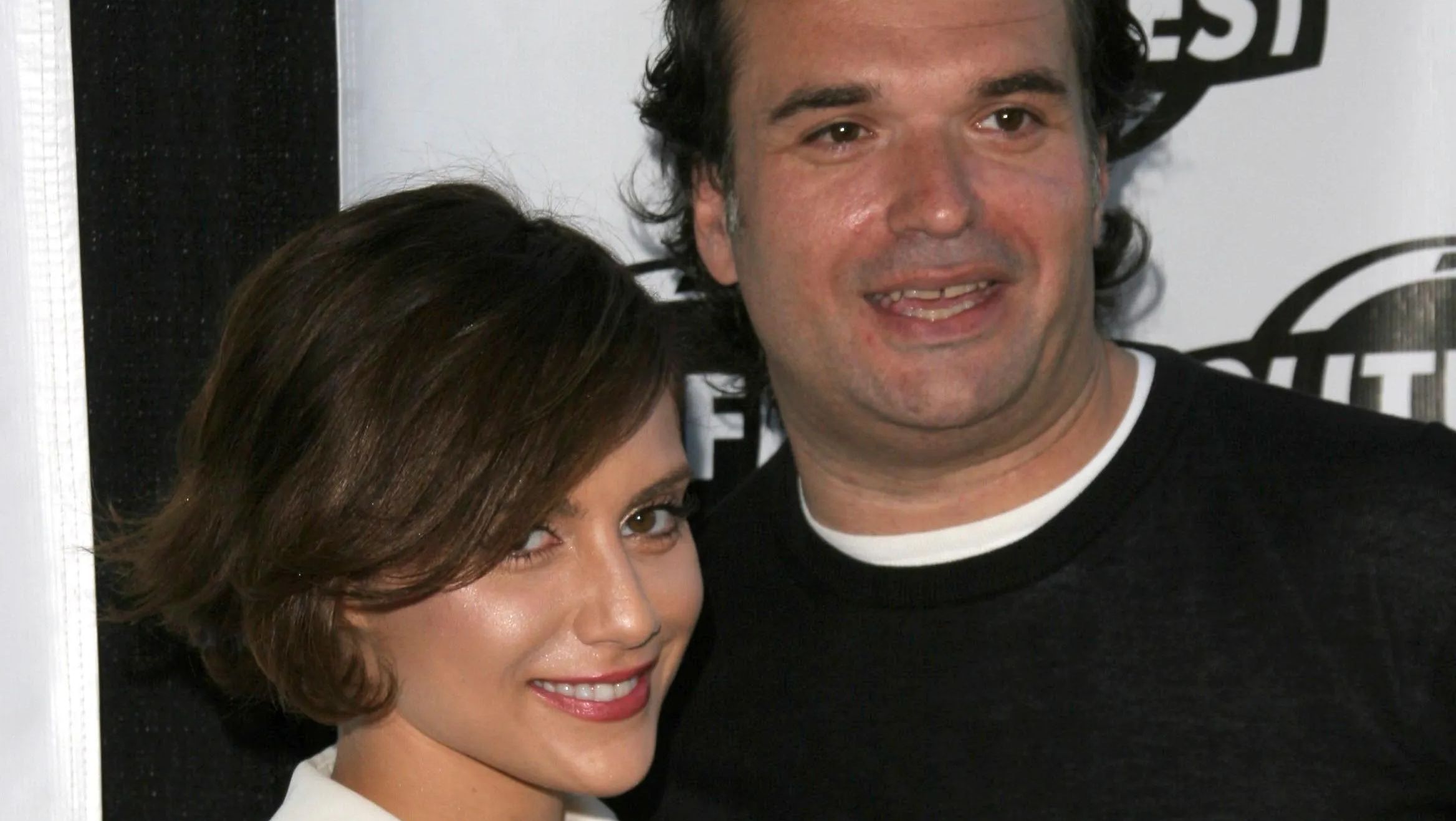 Brittany Murphy and Simon Monjack pose together at an event. 