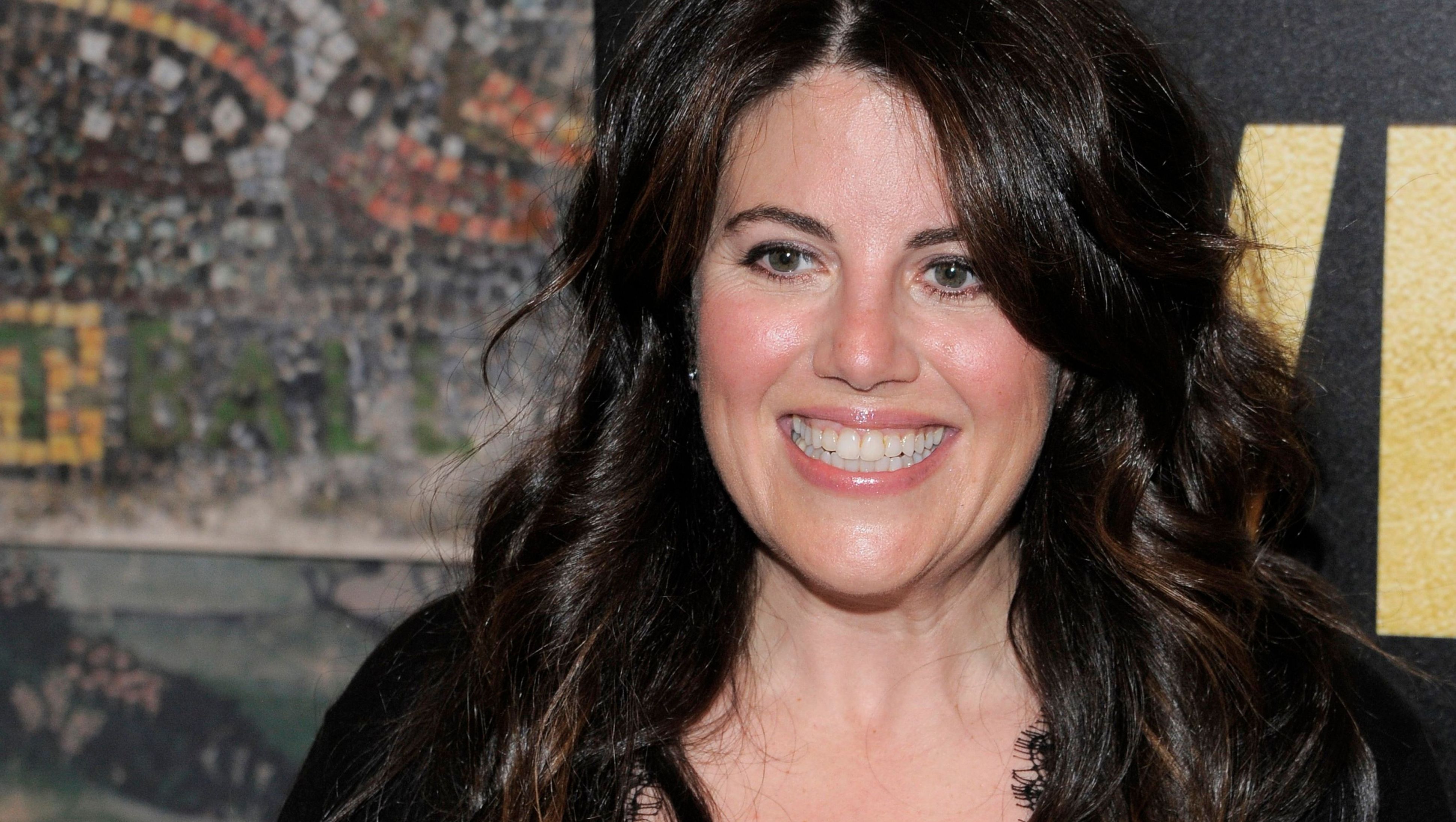 Monica Lewinsky smiles with curled hair.