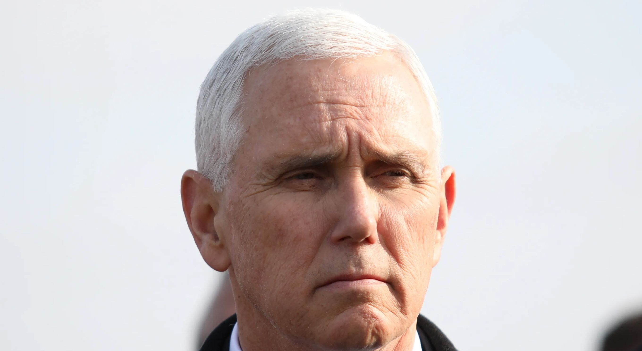 Former Vice President Mike Pence looks on.