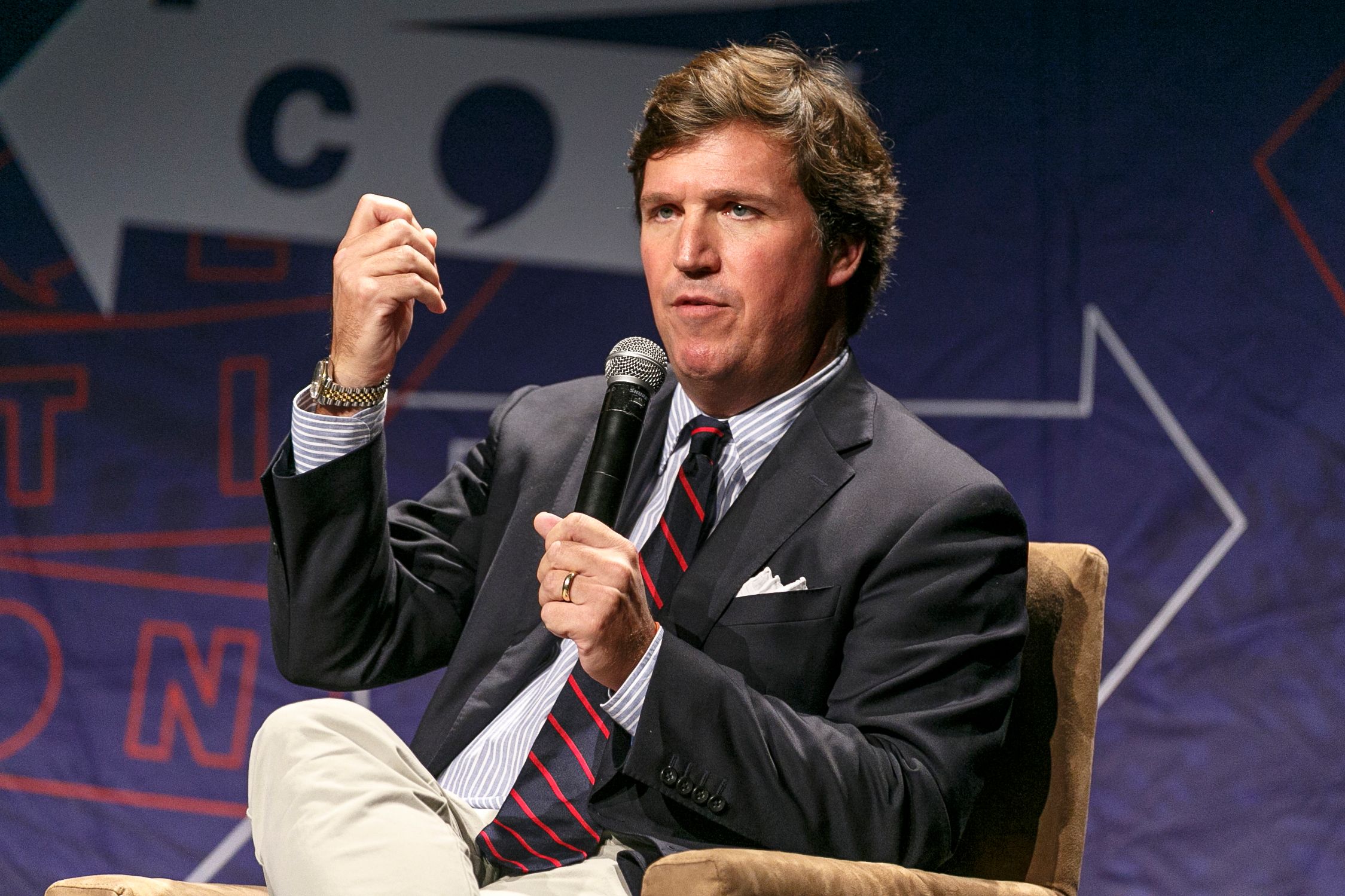 Tucker Carlson speaks at an event.